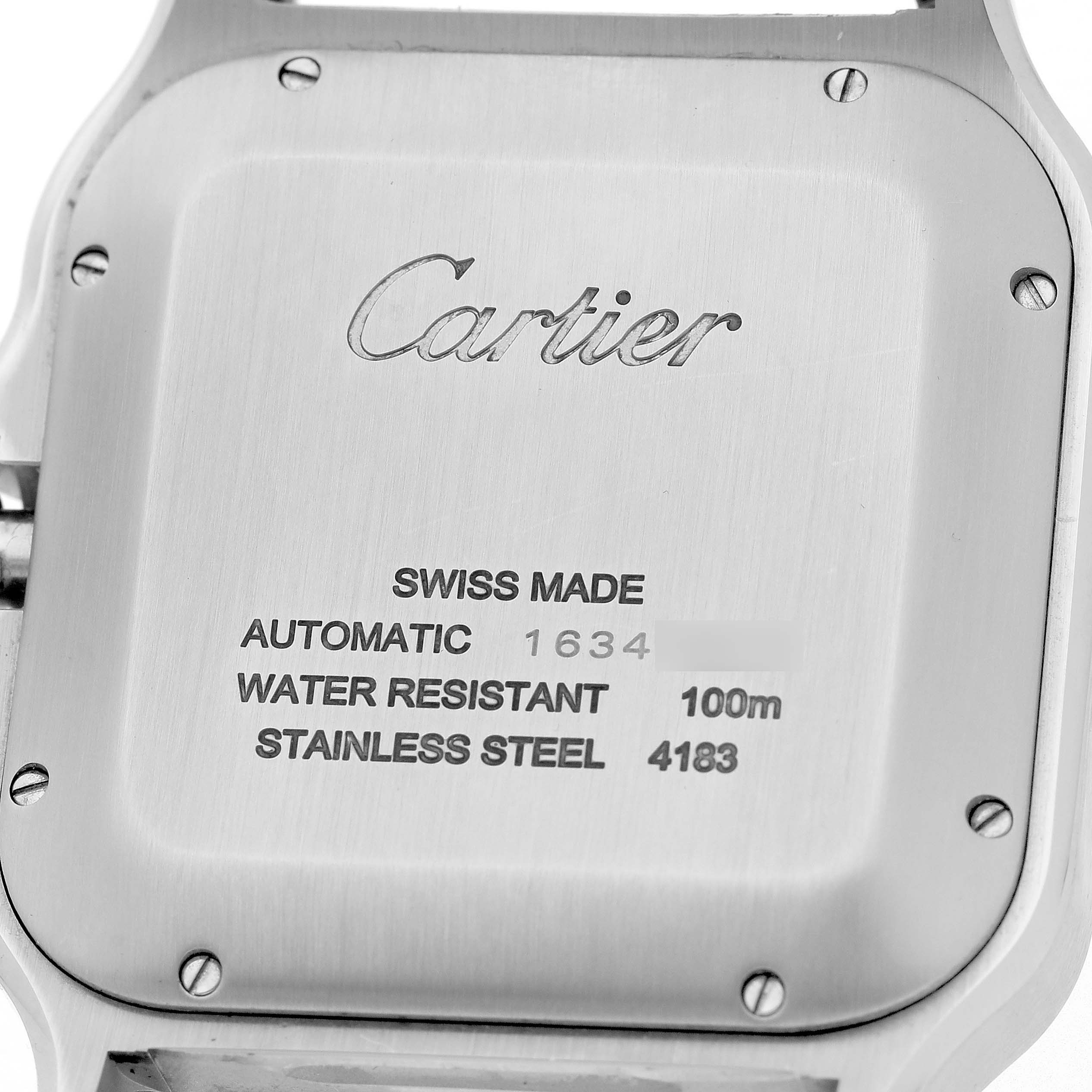 The image shows the case back of the Santos model by Cartier, highlighting engraving details and screw placement.