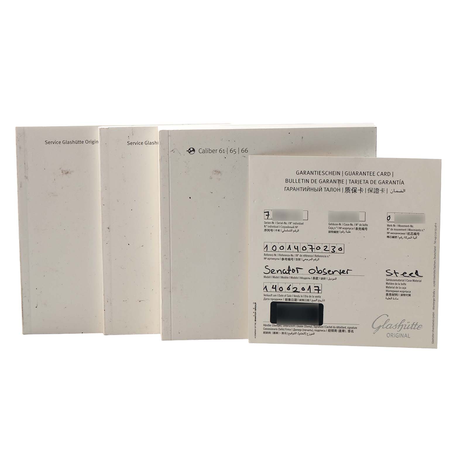 The image displays the Glashütte Senator model's warranty cards and booklets from a frontal angle.