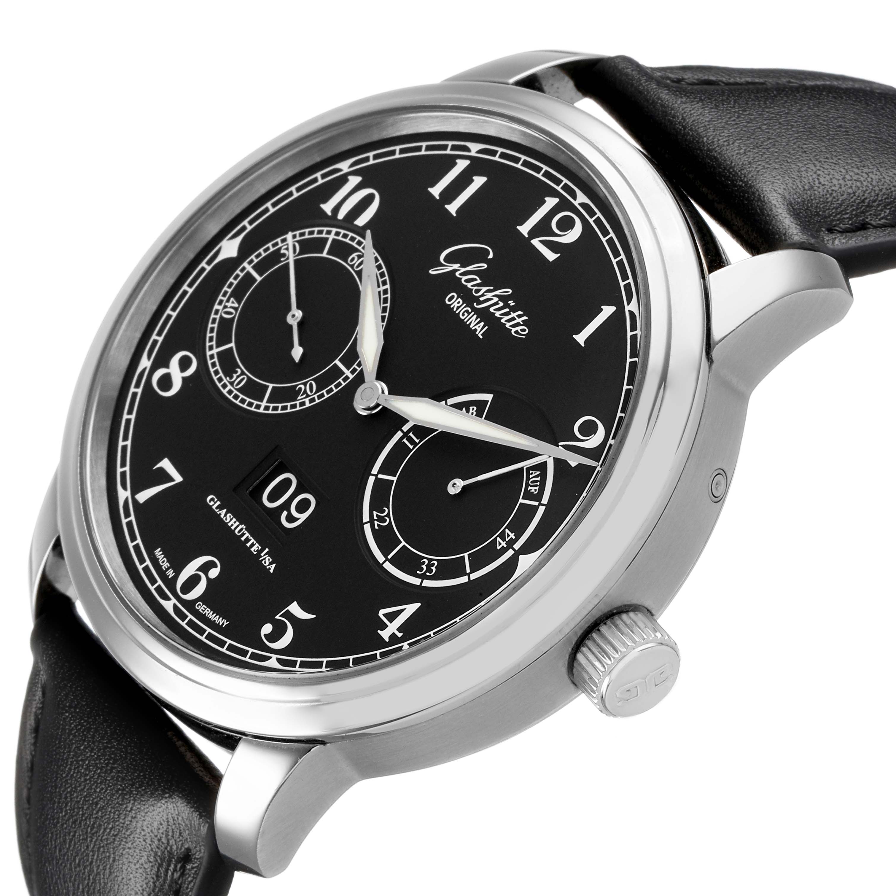 The Glashütte Senator watch is shown at a slight angle, highlighting the black dial, subdials, and crown with a leather strap.