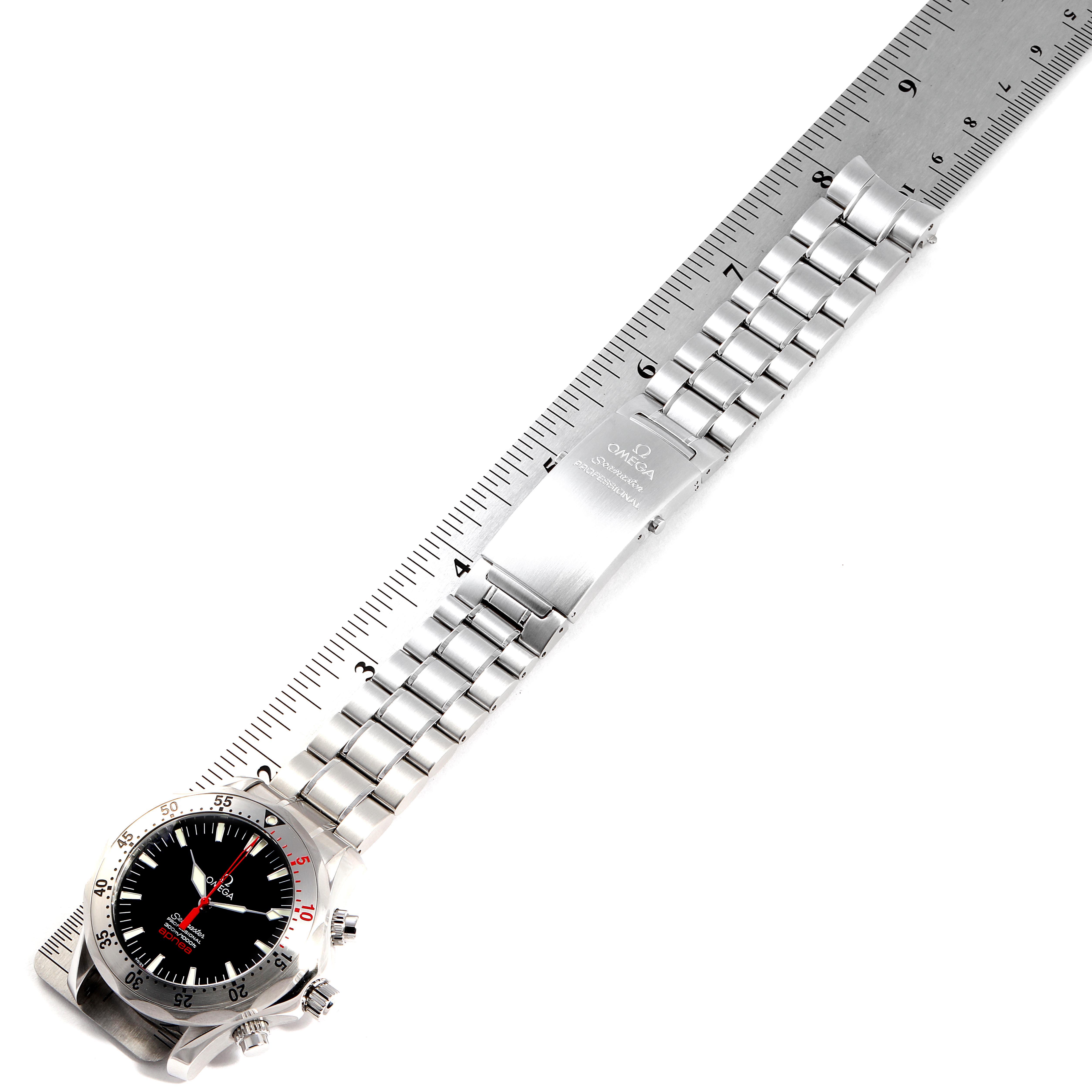 The image shows an Omega Seamaster 2595.50.00 Men's Stainless Steel Black Dial 2595.50.00 Men's Stainless Steel Black Dial watch from a top-down angle, displaying its face, bezel, crown, and metal bracelet next to a ruler.