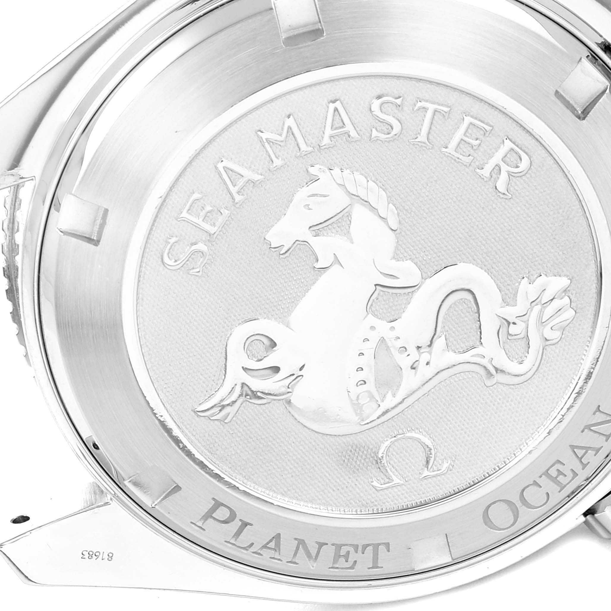 The angle shows the case back of an Omega Seamaster Planet Ocean watch with its engraved design and text.