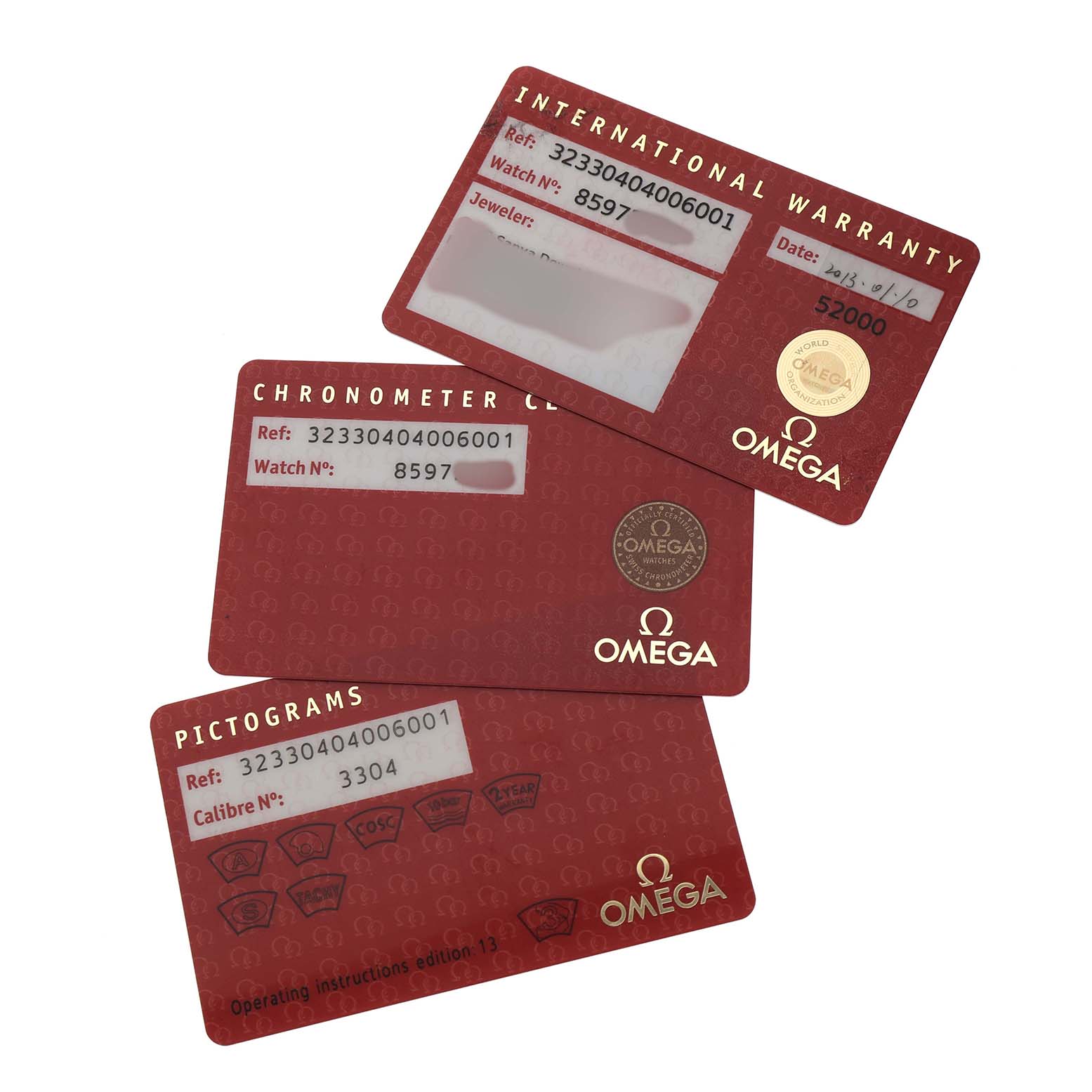 The image shows three Omega Speedmaster 323.30.40.40.06.001 Men's Stainless Steel Grey Dial warranty and information cards laid out flat, overlapping each other.