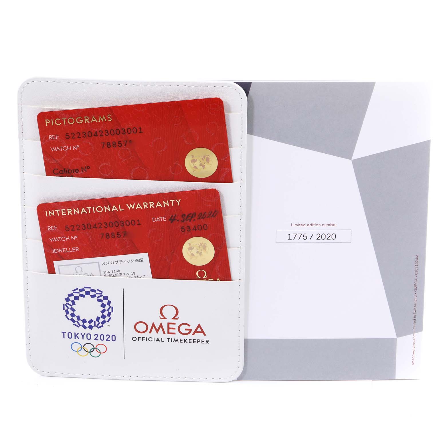 The image shows the warranty cardholder for the Omega Speedmaster 522.30.42.30.03.001 Men's Stainless Steel Blue Dial 522.30.42.30.03.001 Men's Stainless Steel Blue Dial Tokyo 2020 edition, including pictogram and international warranty cards.