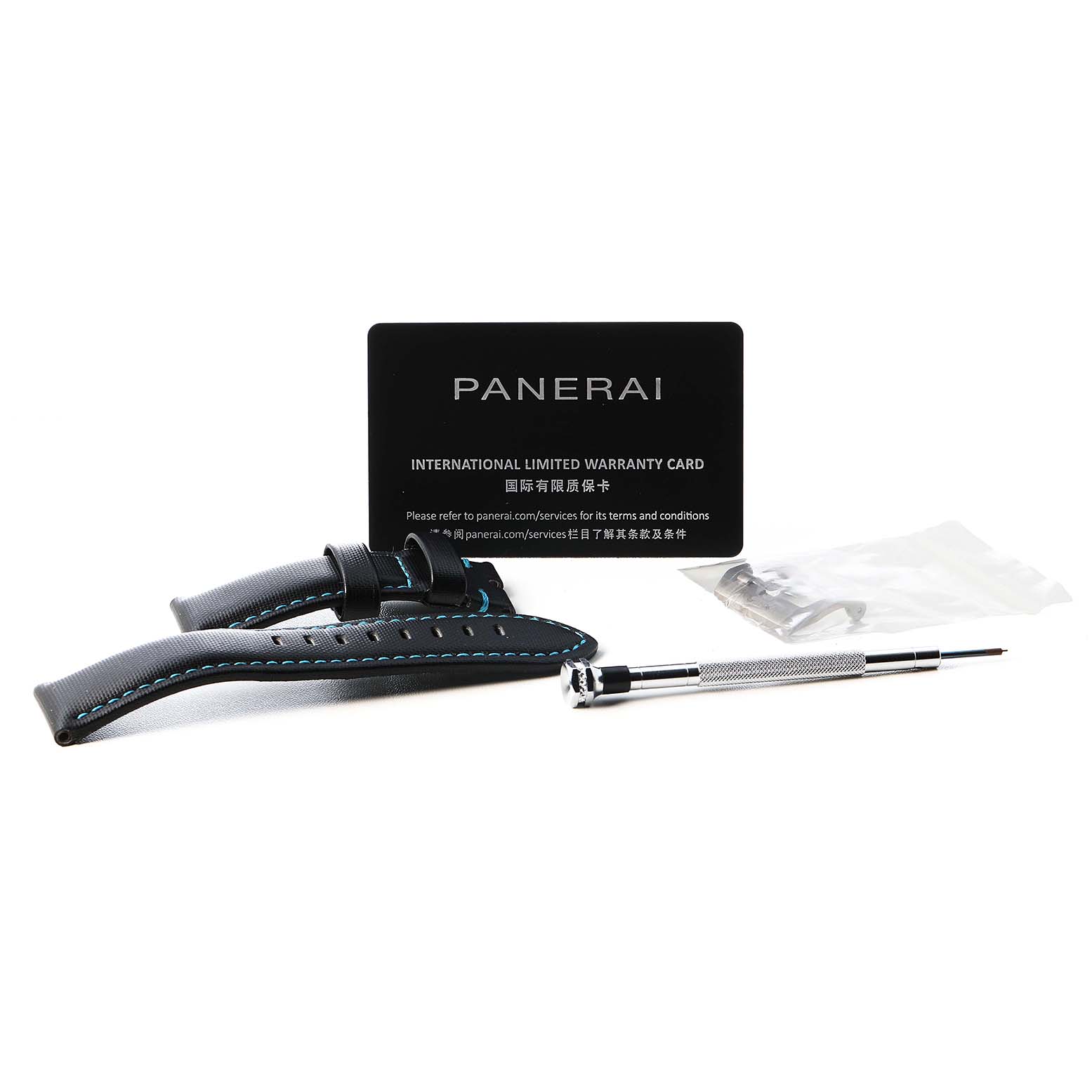 The image shows a Panerai Submersible PAM00799 Men's Titanium Black Dial watch strap, a screwdriver, and a warranty card from a top view.
