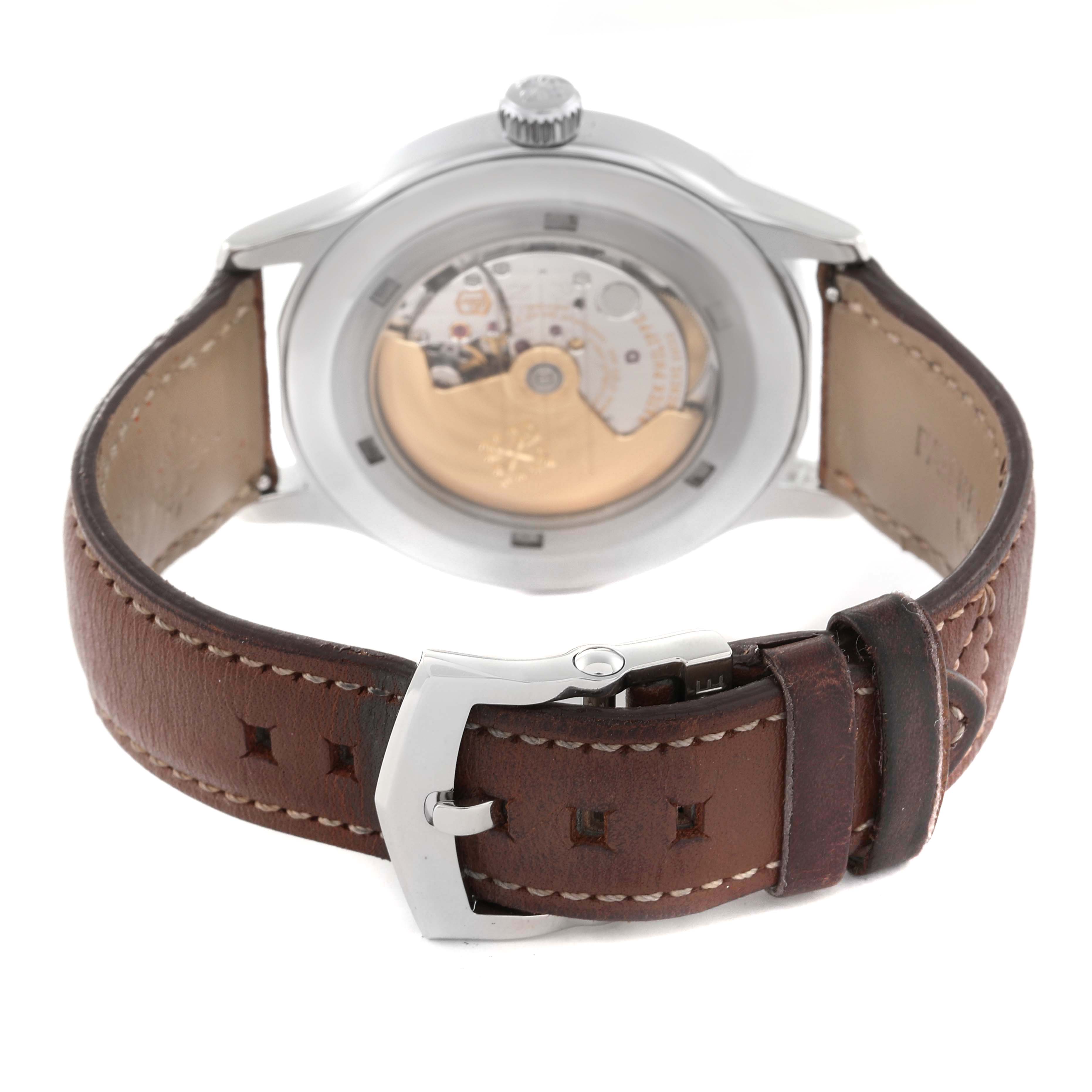 The image shows the back view of a Patek Philippe Calatrava 5522A-001 Men's Stainless Steel Blue Dial 5522A-001 Men's Stainless Steel Blue Dial watch, displaying the movement and brown leather strap.