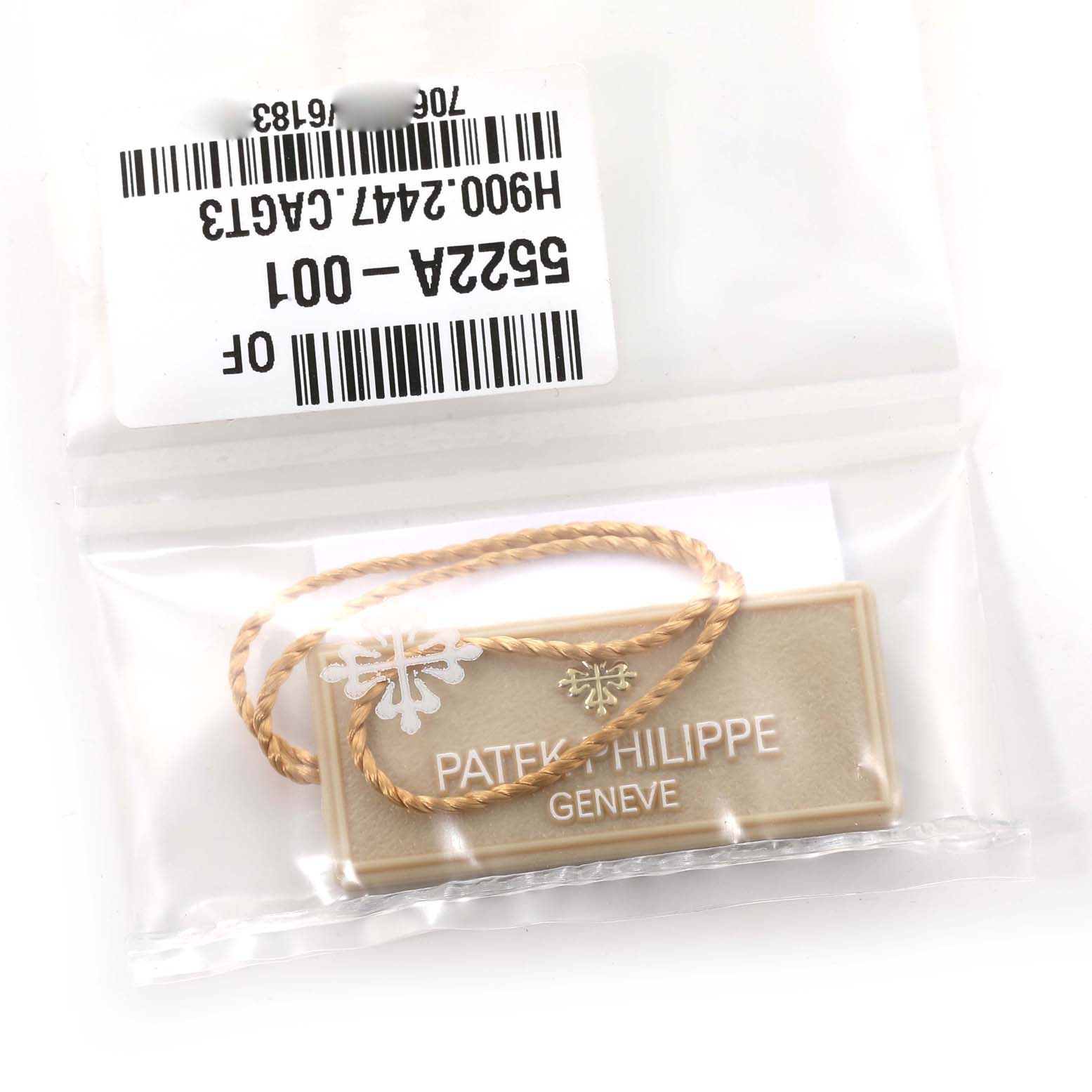 The image shows a tag and labels for a Calatrava model by Patek Philippe inside a clear plastic bag.