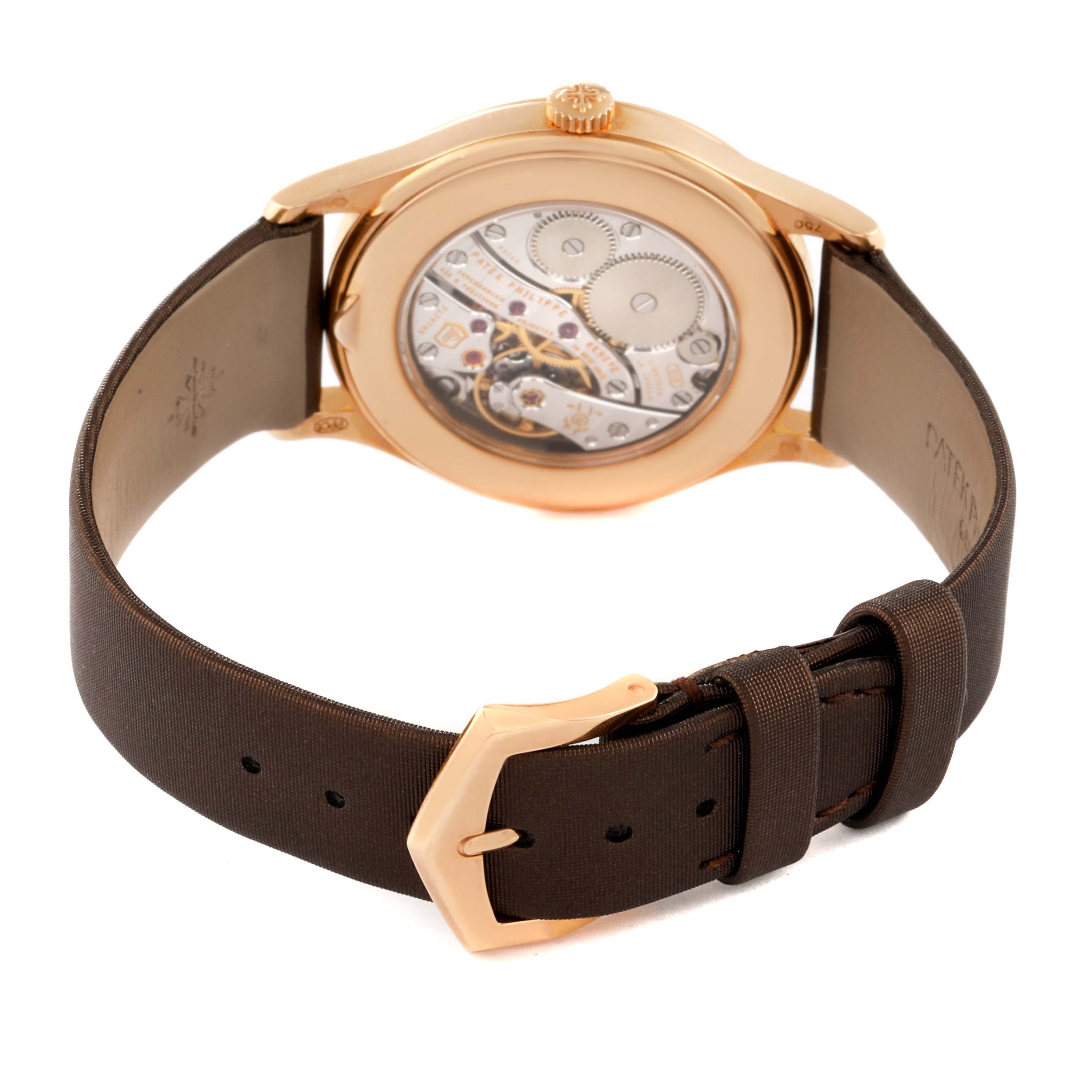 The image shows the back view of a Patek Philippe Calatrava 4897R-001 Women
s Rose Gold Brown Dial 4897R-001 Women
s Rose Gold Brown Dial, highlighting the watch
s movement and strap with a buckle.