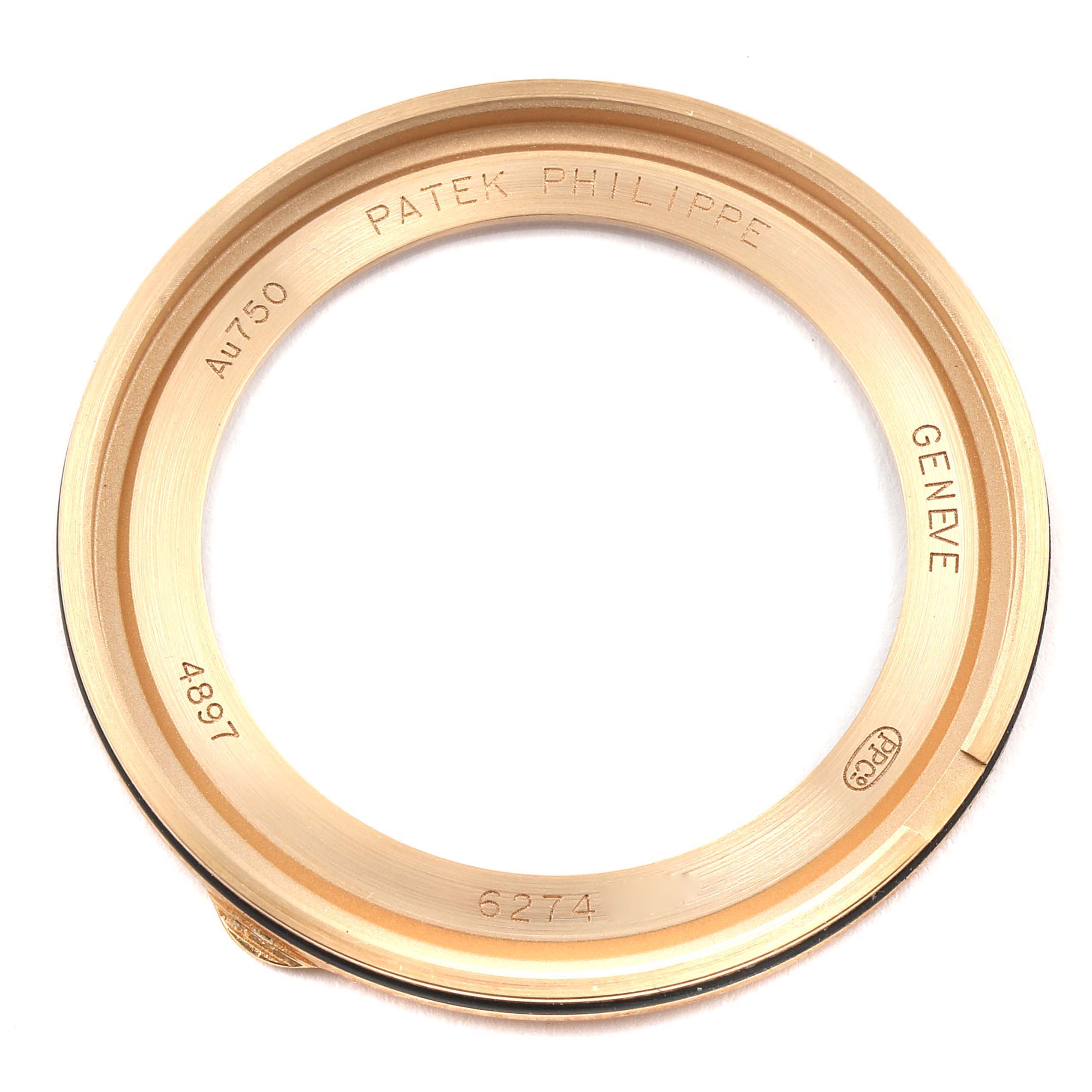 The image shows the gold bezel ring of a Patek Philippe Calatrava 4897R-001 Women
s Rose Gold Brown Dial 4897R-001 Women
s Rose Gold Brown Dial watch from a top-down view.