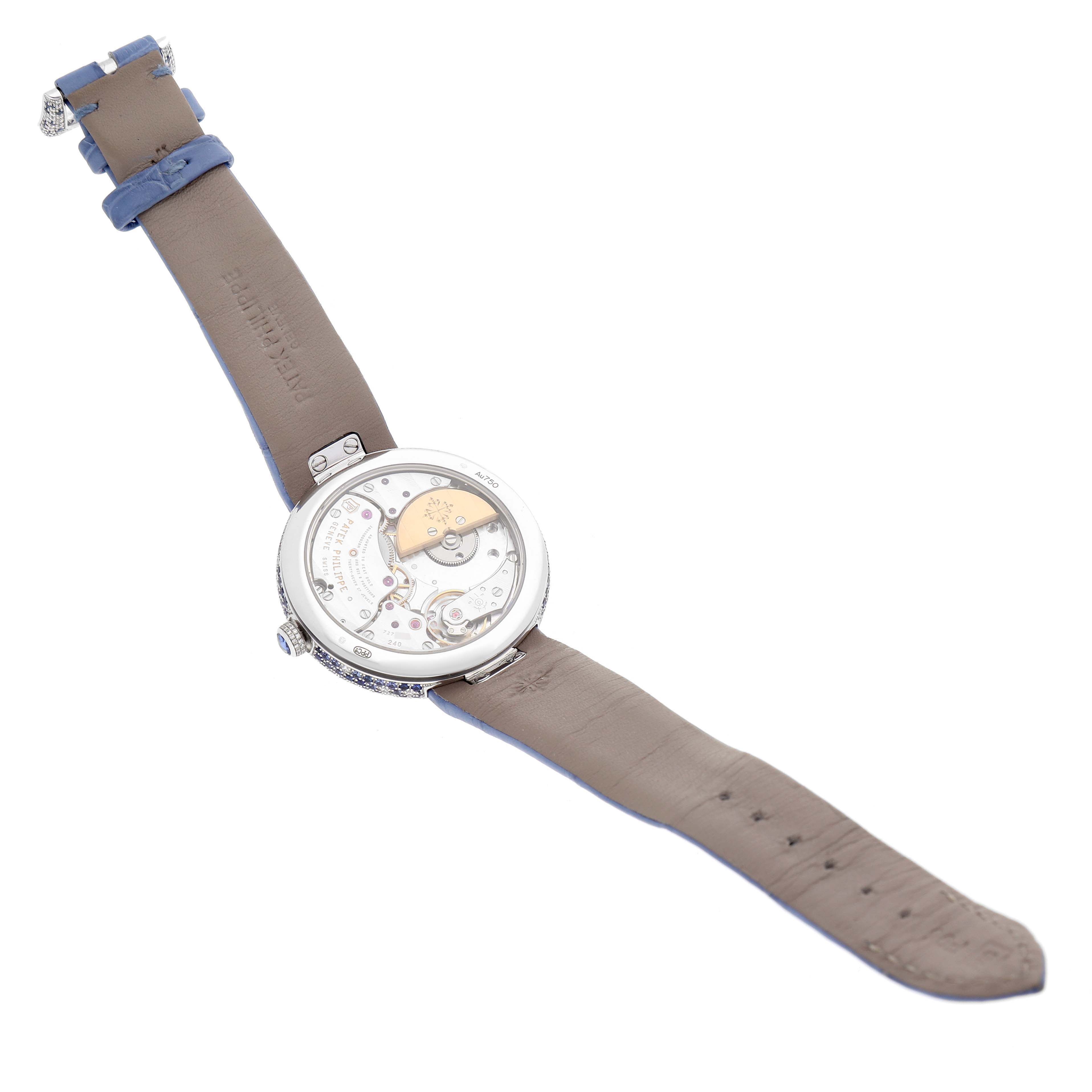 The image shows the back view of a Patek Philippe Calatrava 4899/901G Women's White Gold Mother of Pearl Dial 4899/901G Women's White Gold Mother of Pearl Dial watch, revealing its intricate movement and leather strap.