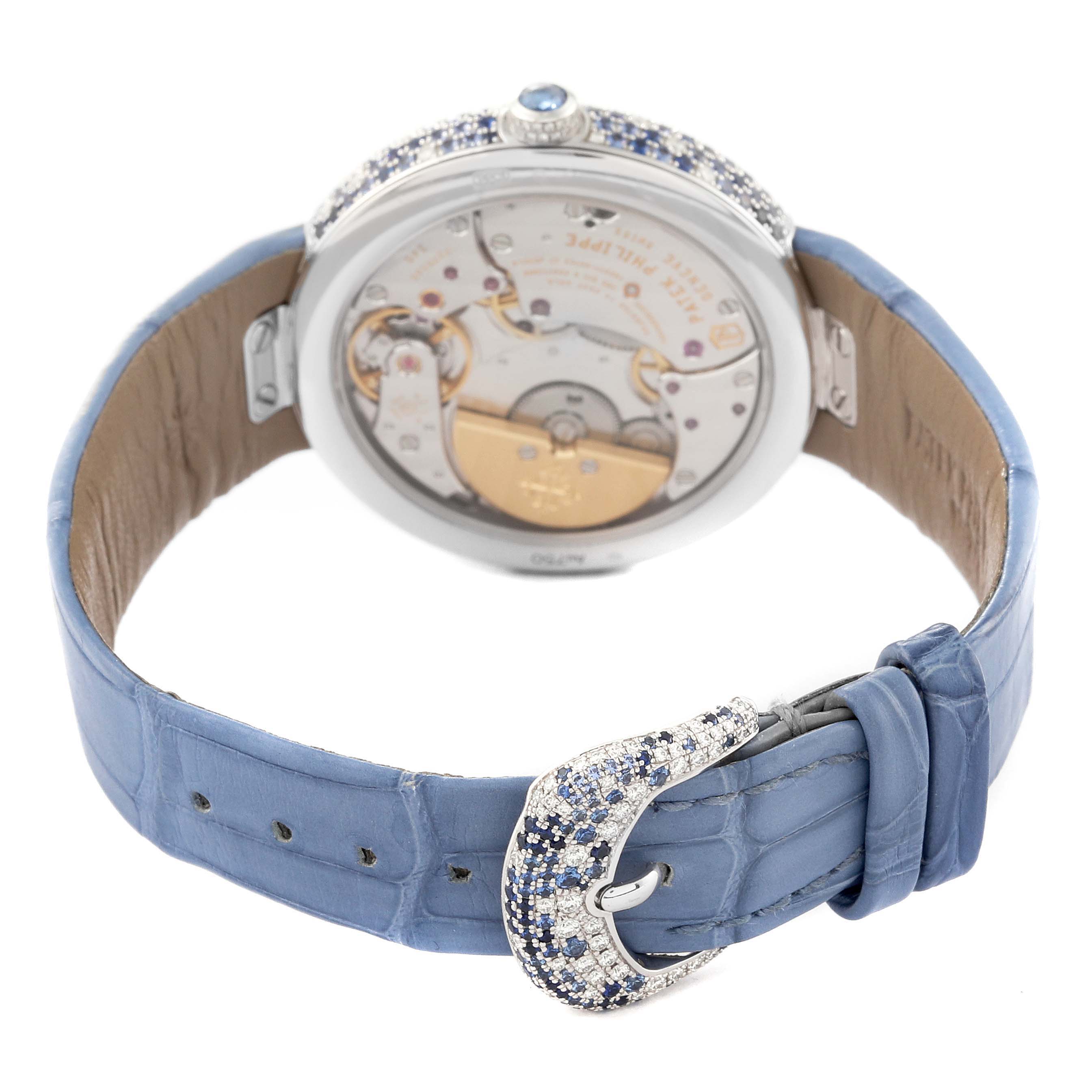 The image shows the back view of a Patek Philippe Calatrava 4899/901G Women's White Gold Mother of Pearl Dial 4899/901G Women's White Gold Mother of Pearl Dial watch, emphasizing its movement and leather strap with a jeweled buckle.