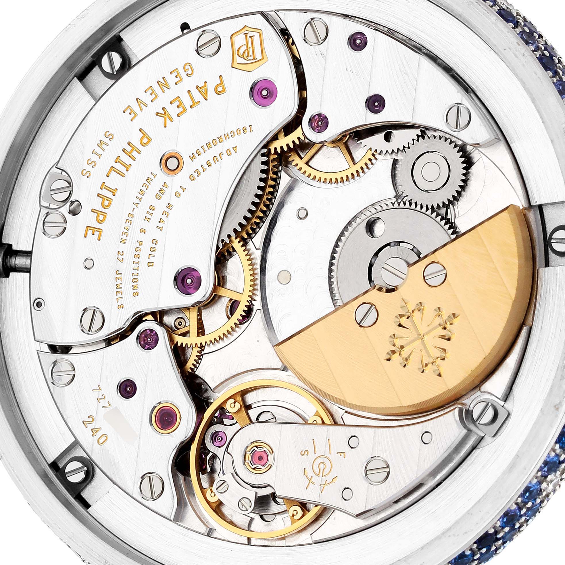 This image shows the intricate internal mechanism of a Patek Philippe Calatrava 4899/901G Women's White Gold Mother of Pearl Dial 4899/901G Women's White Gold Mother of Pearl Dial watch, focusing on its movement and gears.