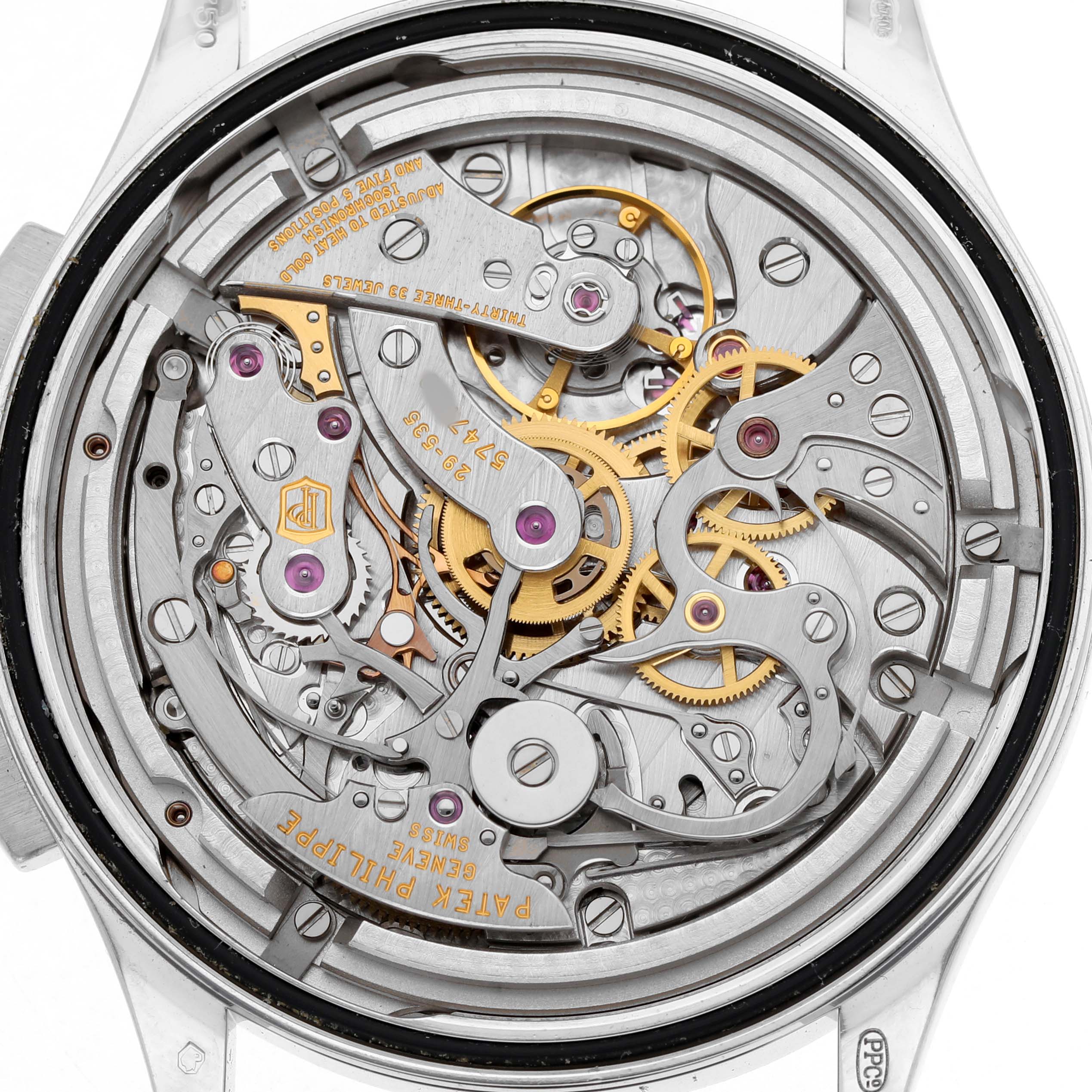 The image shows the movement of a Patek Philippe Complications 5170G-001 Men's White Gold White Dial watch, revealing gears and intricate mechanical parts from a back view.