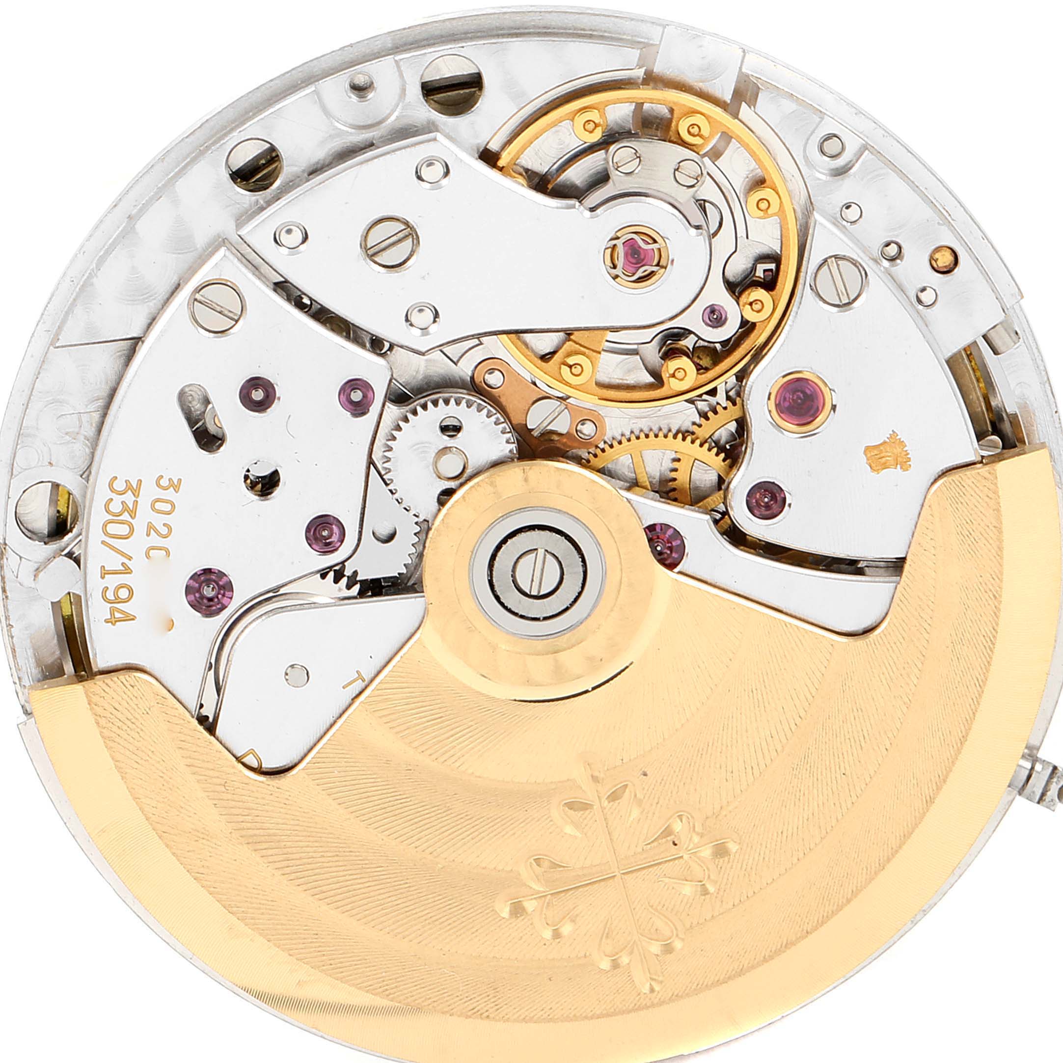 The image shows the movement of a Patek Philippe Nautilus 3800/1 Men's Stainless Steel White Dial 3800/1 Men's Stainless Steel White Dial watch, highlighting gears, jewels, and the rotor from a top view.