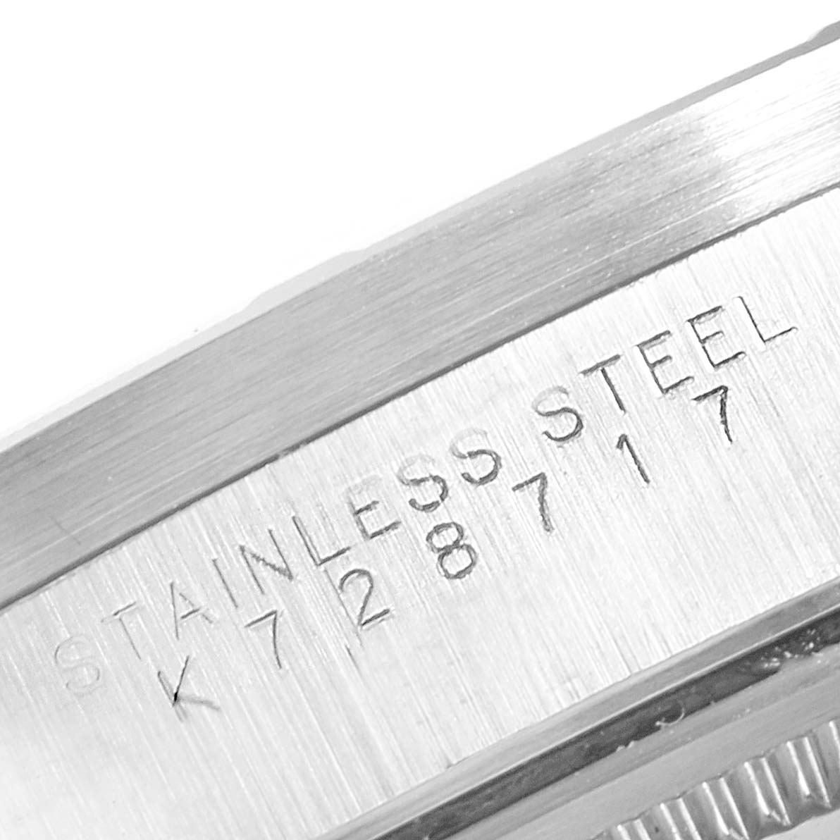 This image shows a close-up view of the serial number and "stainless steel" engraving on a Rolex Air-King 14010 Men's Stainless Steel Blue Dial 14010 Men's Stainless Steel Blue Dial watch case.