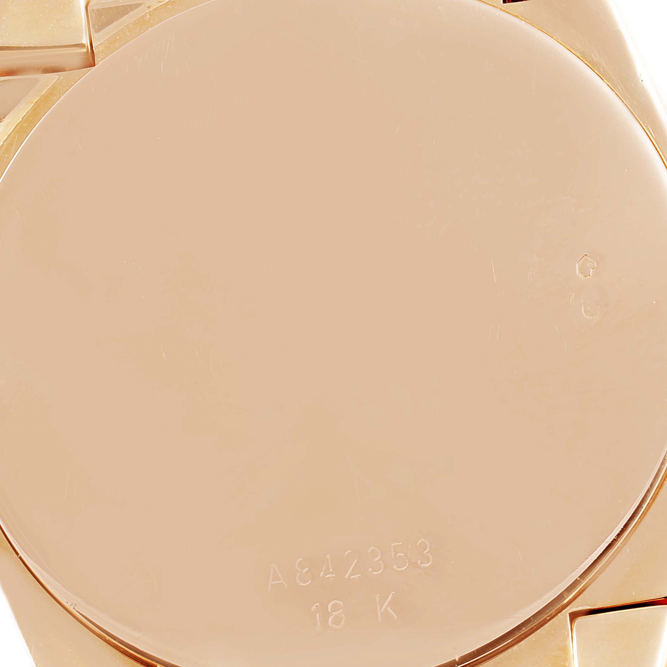 This close-up image shows the back case of a Rolex Cellini 5330 Men's Rose Gold White Dial 5330 Men's Rose Gold White Dial watch with its serial number and "18K" marking.