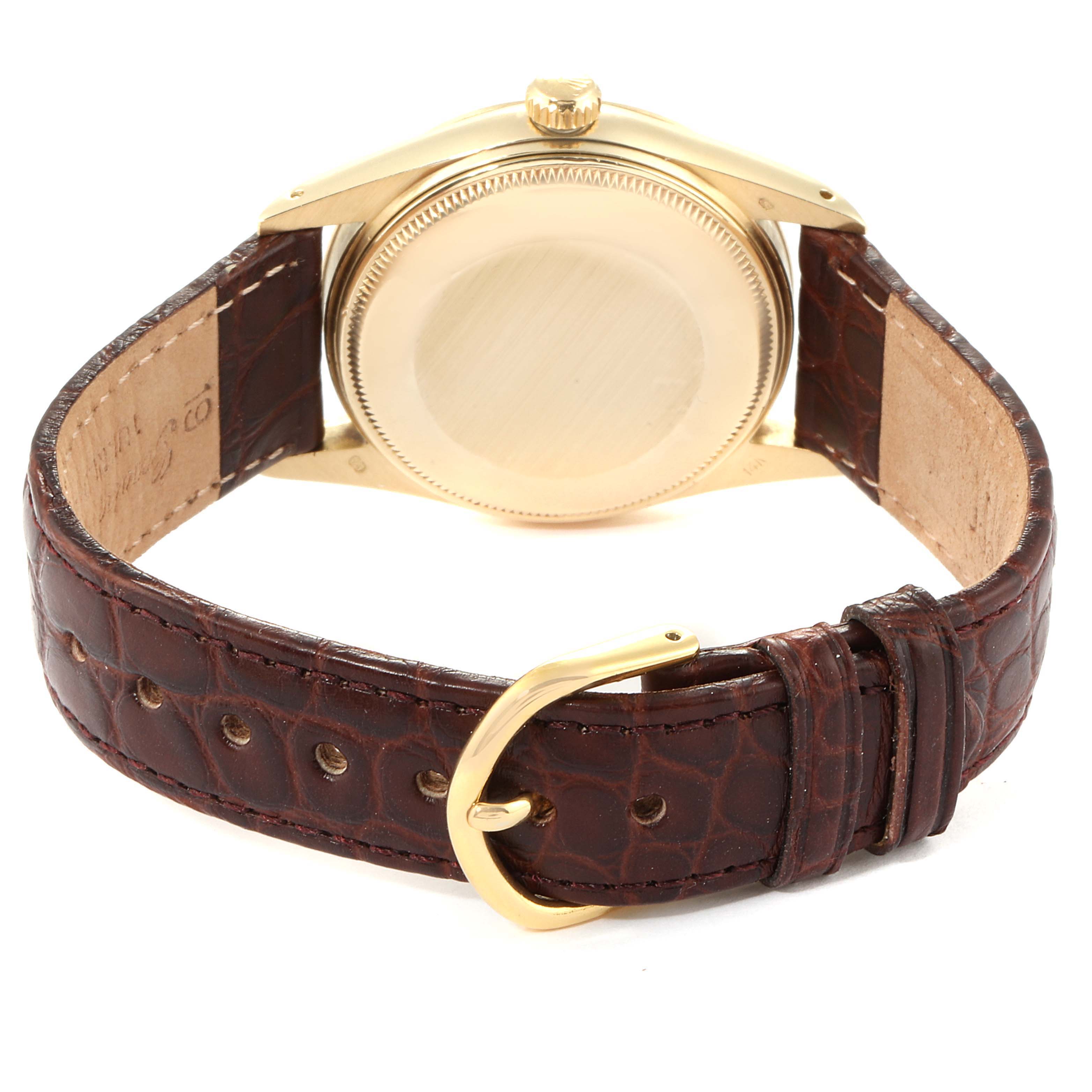 This image shows the back of the Vintage Collection Rolex watch, highlighting its case and brown leather strap with a gold buckle.