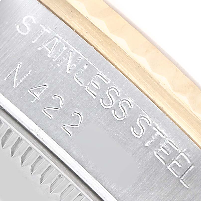 The image shows the side of a Rolex Mid-Size 68273 Women's Steel and Gold (two tone) White Dial watch case with inscriptions "STAINLESS STEEL" and partial serial number.