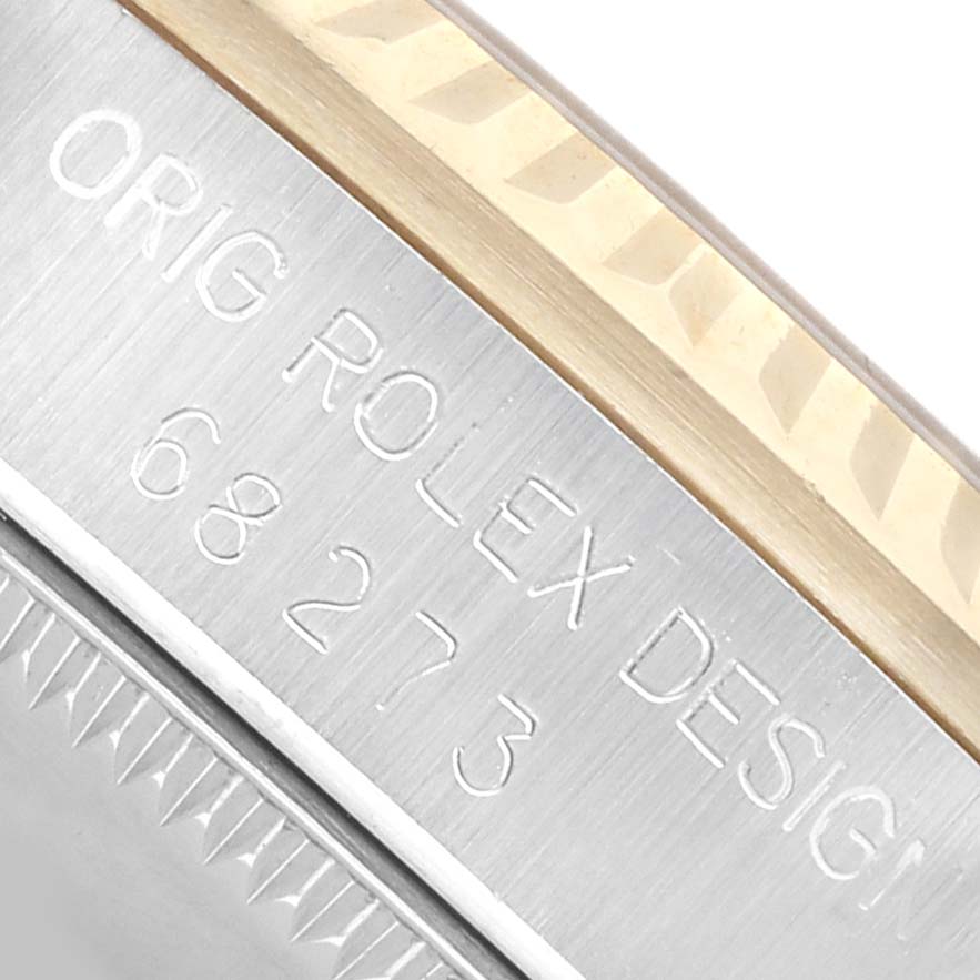 The image shows a close-up of the case side of a Rolex Mid-Size 68273 Women's Steel and Gold (two tone) White Dial watch, highlighting the engraved serial number and model details.