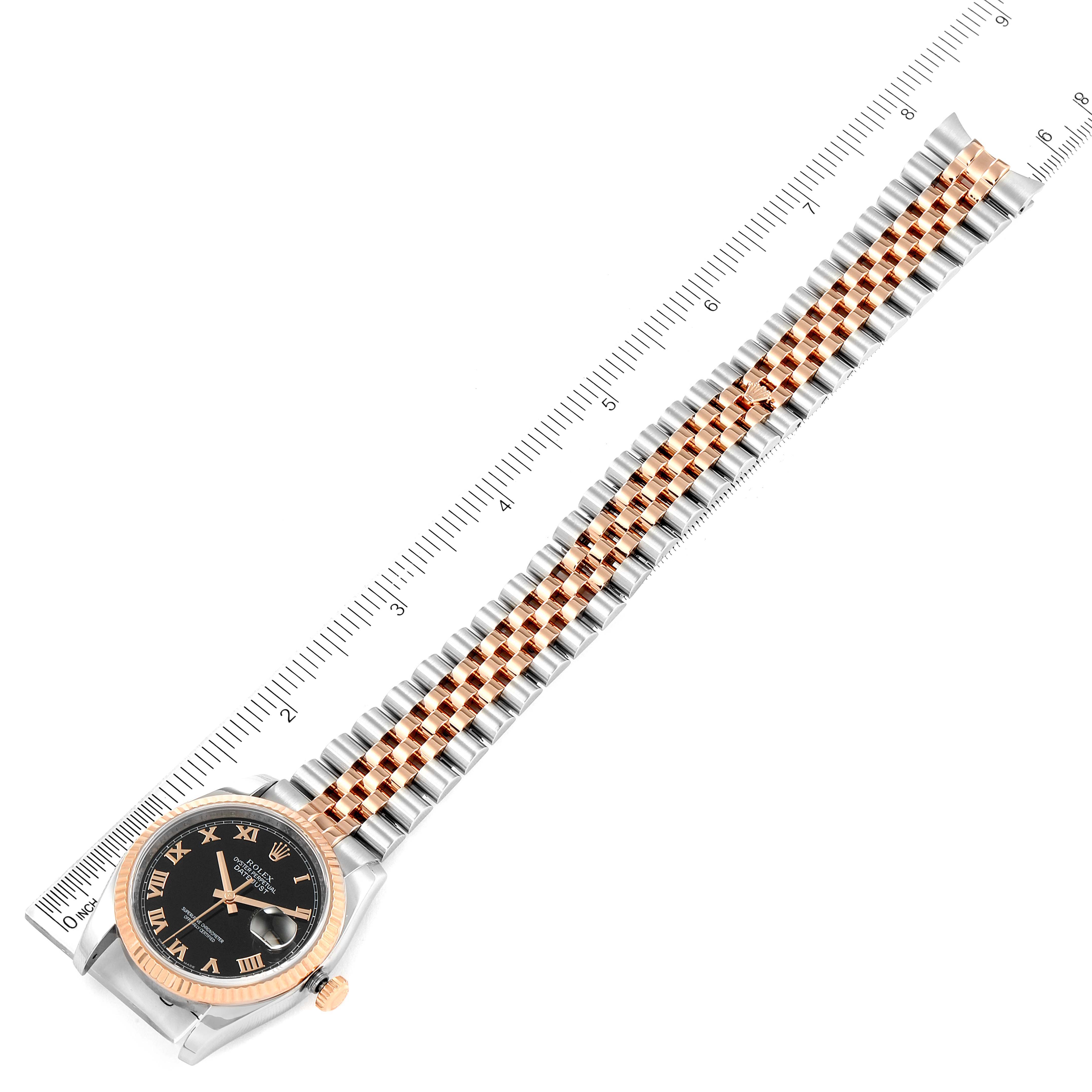 The image shows a Rolex Datejust 116231 Men's Steel and Gold (two tone) Black Dial 116231 Men's Steel and Gold (two tone) Black Dial watch laid flat, highlighting the face, bezel, and bracelet alongside a ruler for scale.