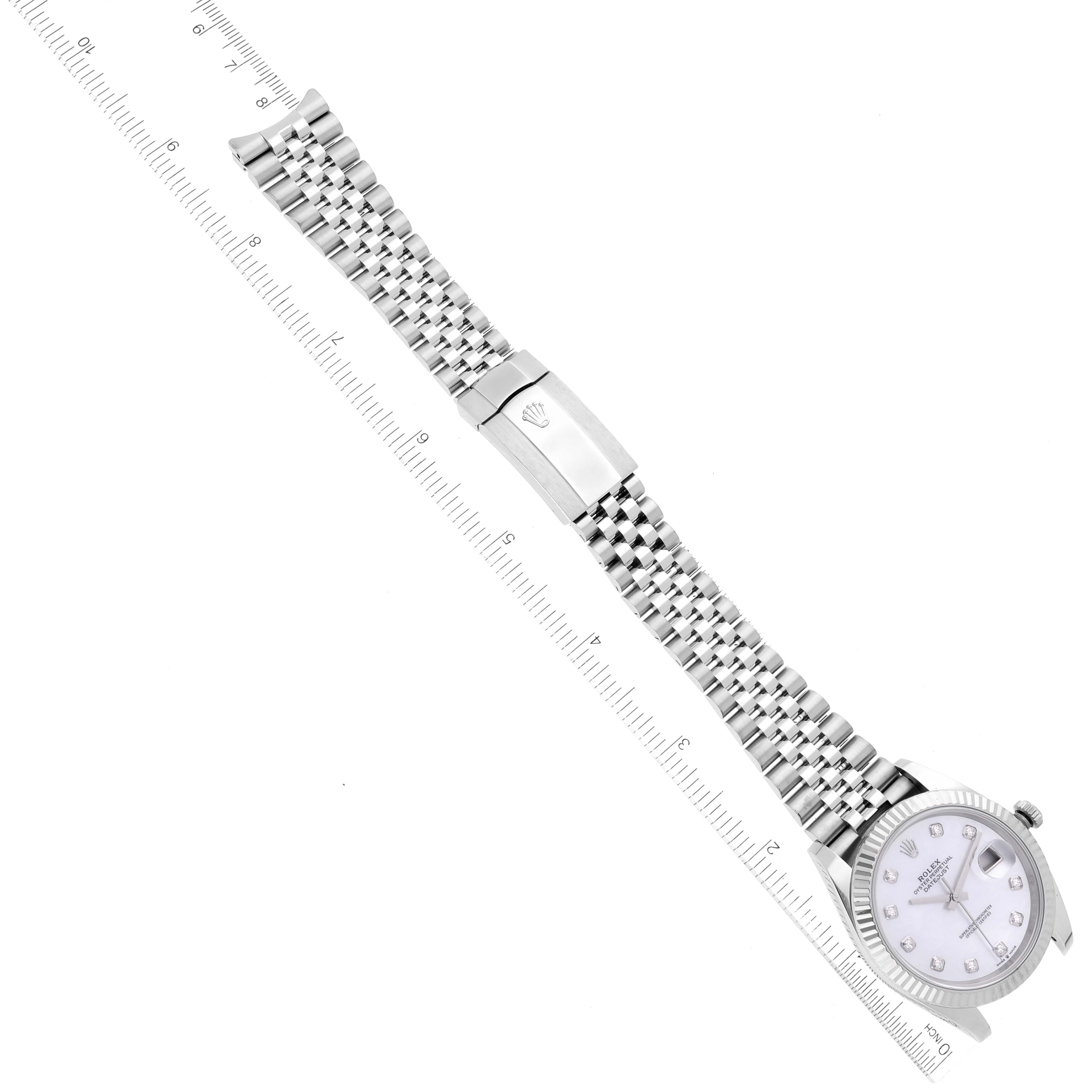 The image shows a top-down view of a Rolex Datejust 41 126334 Men's Stainless Steel Mother of Pearl Dial 126334 Men's Stainless Steel Mother of Pearl Dial watch with its bracelet fully extended alongside a measuring ruler.