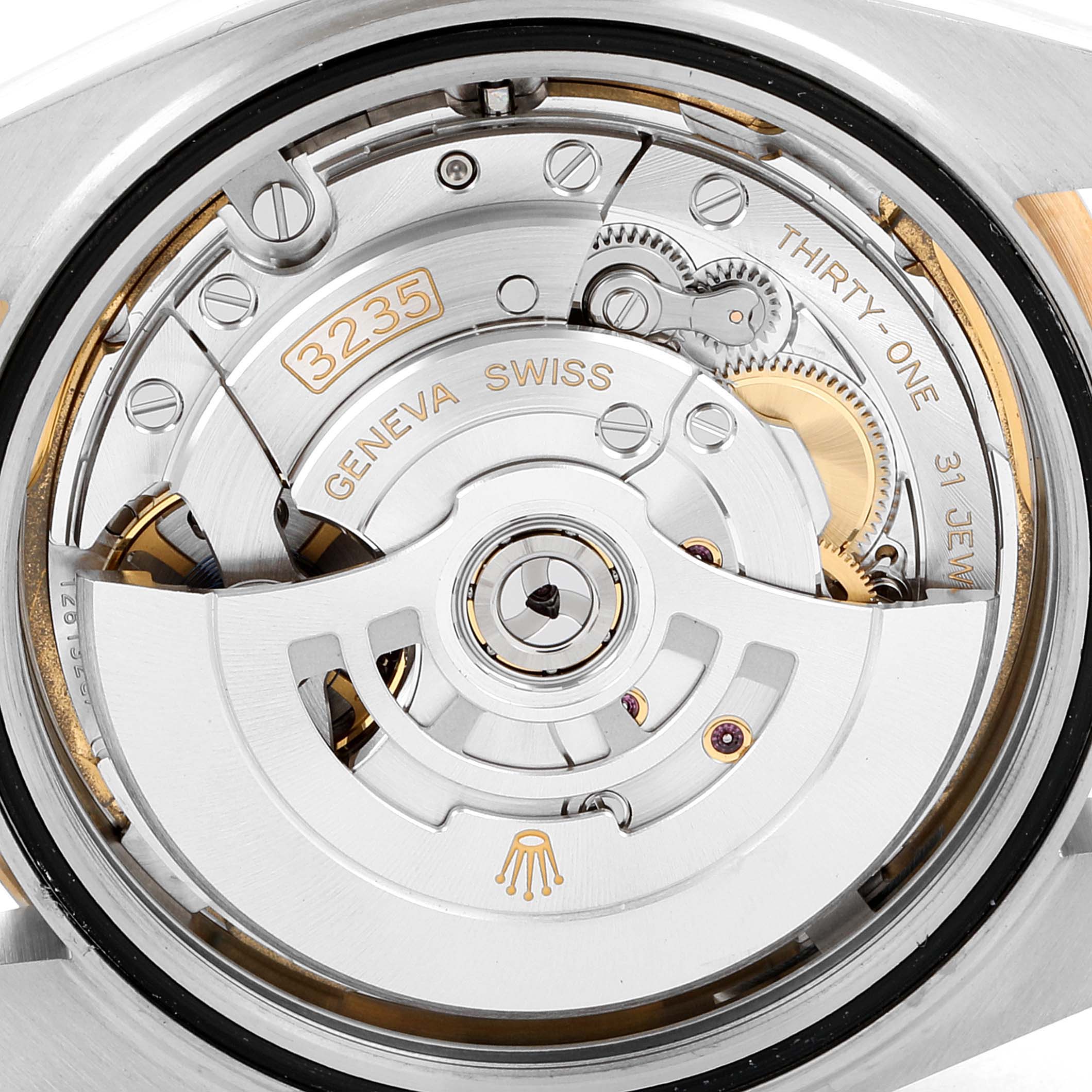 The image shows a close-up of the movement mechanism inside the Rolex Datejust 41 126333 Men's Stainless Steel White Dial 126333 Men's Stainless Steel White Dial watch, revealing the intricate gears and parts.