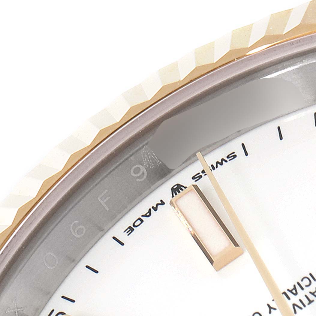 This close-up image of the Rolex Datejust 41 126333 Men's Stainless Steel White Dial 126333 Men's Stainless Steel White Dial watch highlights the edge of the bezel, part of the dial, and the minute hand.