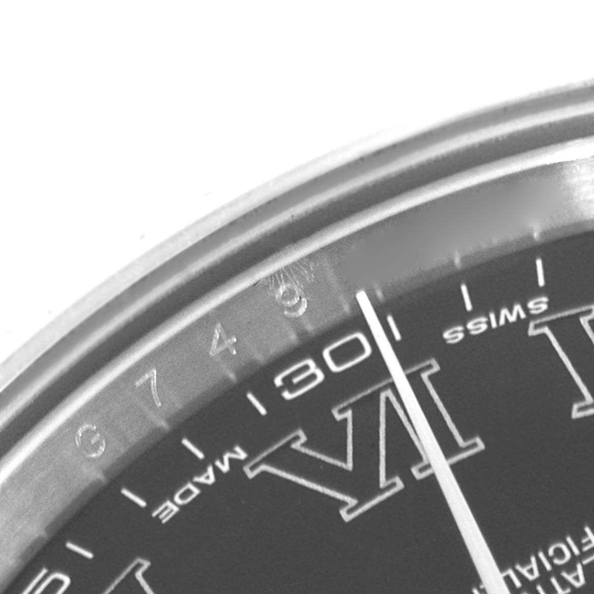 The image shows a partial close-up of the Rolex Datejust 41 116334 Men's Stainless Steel Grey Dial 116334 Men's Stainless Steel Grey Dial watch face, specifically highlighting the minute markers and the Roman numeral VI.