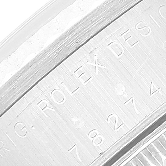 This image shows an angled close-up of the engraved case back of a Mid-Size Rolex watch.