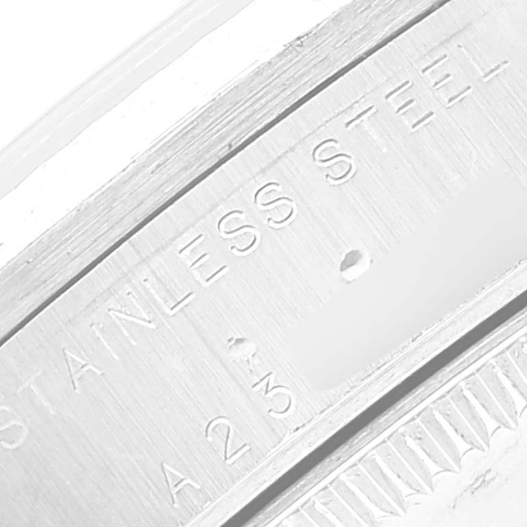 This image shows a close-up of the serial number and "STAINLESS STEEL" engraving on a Rolex Mid-Size 78274 Women
s Stainless Steel Silver Dial 78274 Women
s Stainless Steel Silver Dial model watch.