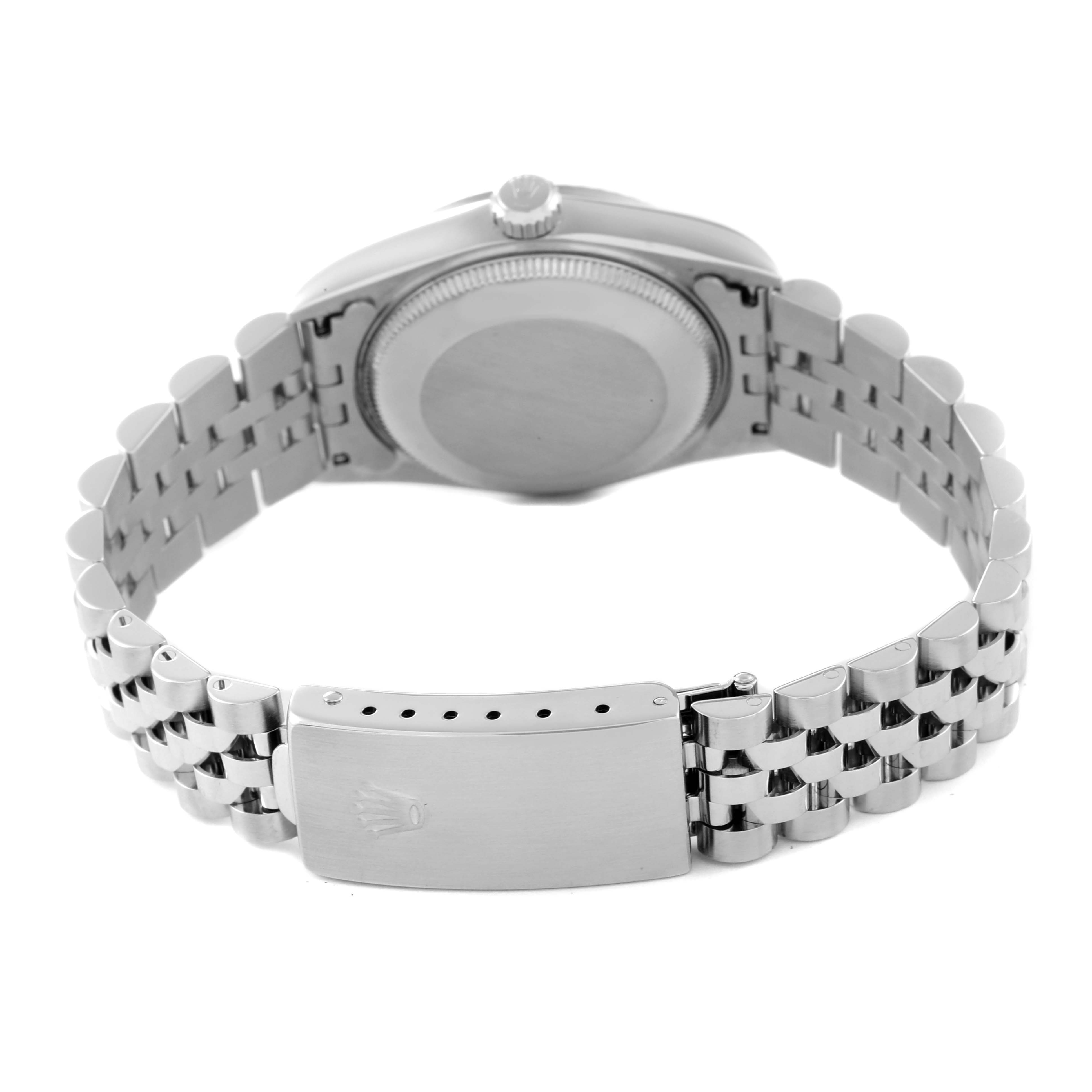 The image shows the backside of a Mid-Size Rolex watch, highlighting the case back, crown, and bracelet with the clasp.