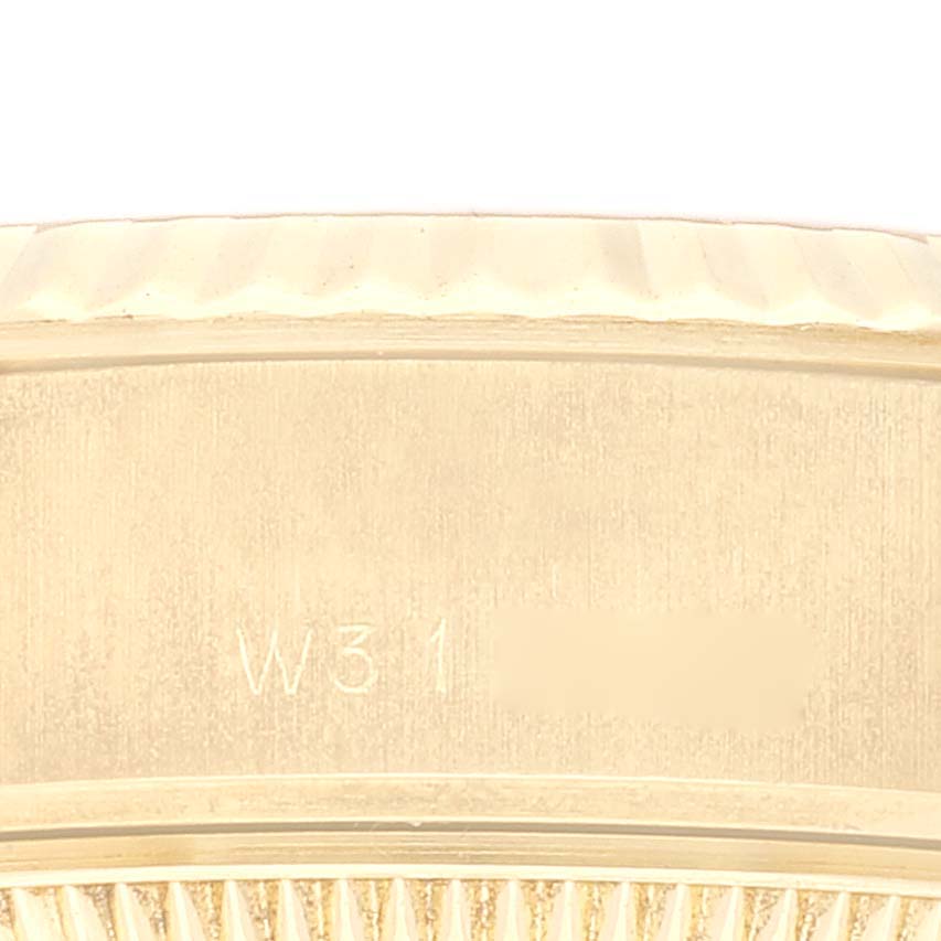 The image shows a close-up view of a Rolex President 69178 Women's Yellow Gold White Dial 69178 Women's Yellow Gold White Dial model, focusing on part of the case with an engraved serial number.