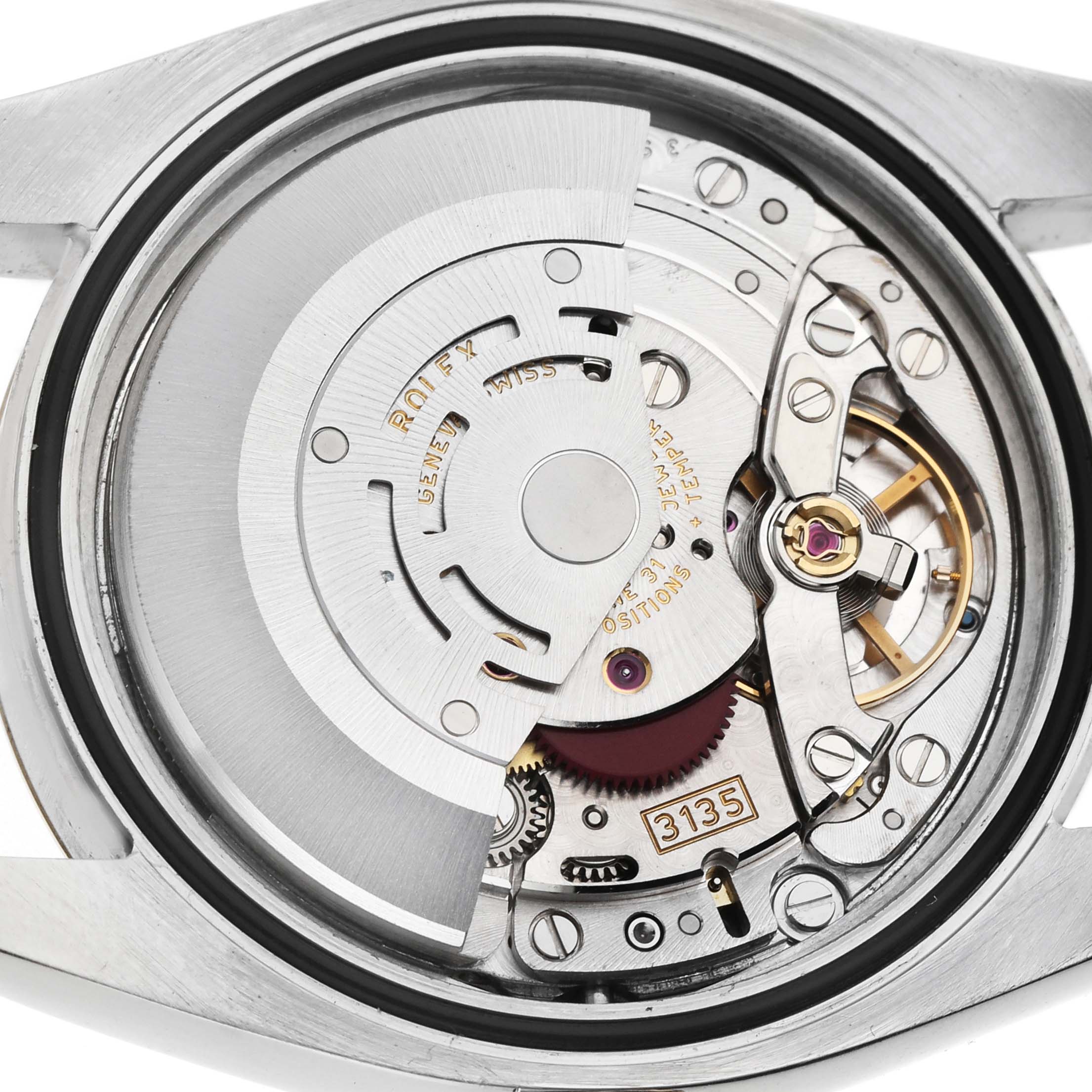 The image shows the open case back of a Rolex Datejust 116233 Men's Steel and Gold (two tone) Silver Dial, displaying its movement components and rotor from a direct overhead angle.