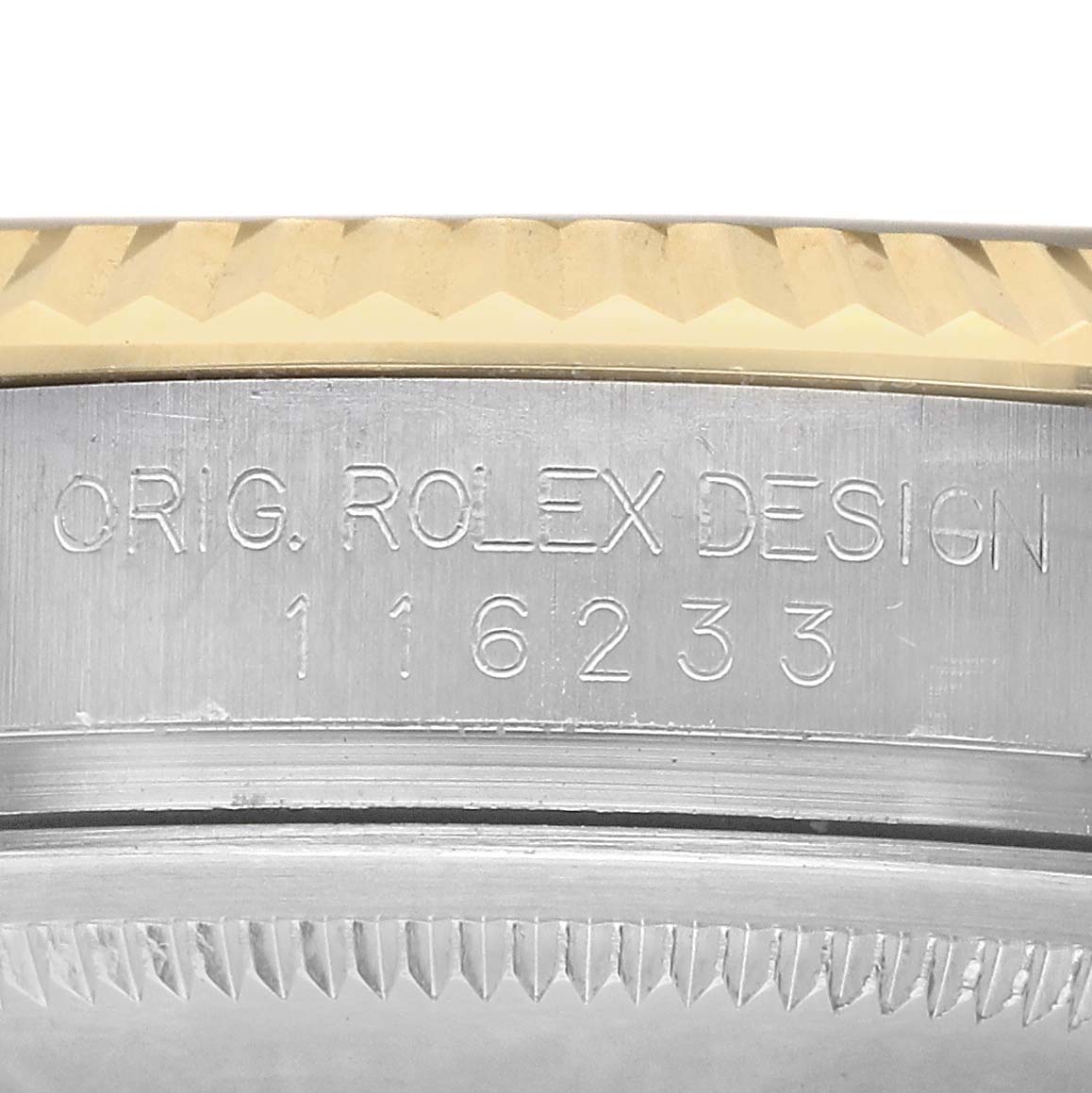 The image shows the side of a Rolex Datejust 116233 Men's Steel and Gold (two tone) Silver Dial watch case, displaying the engraved model number and design.