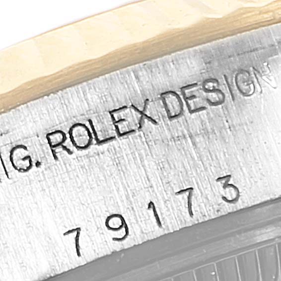 This image shows a close-up of the serial number and engraving on the case of a Rolex Datejust 69173 Women's Steel and Gold (two tone) White Dial 69173 Women's Steel and Gold (two tone) White Dial watch.