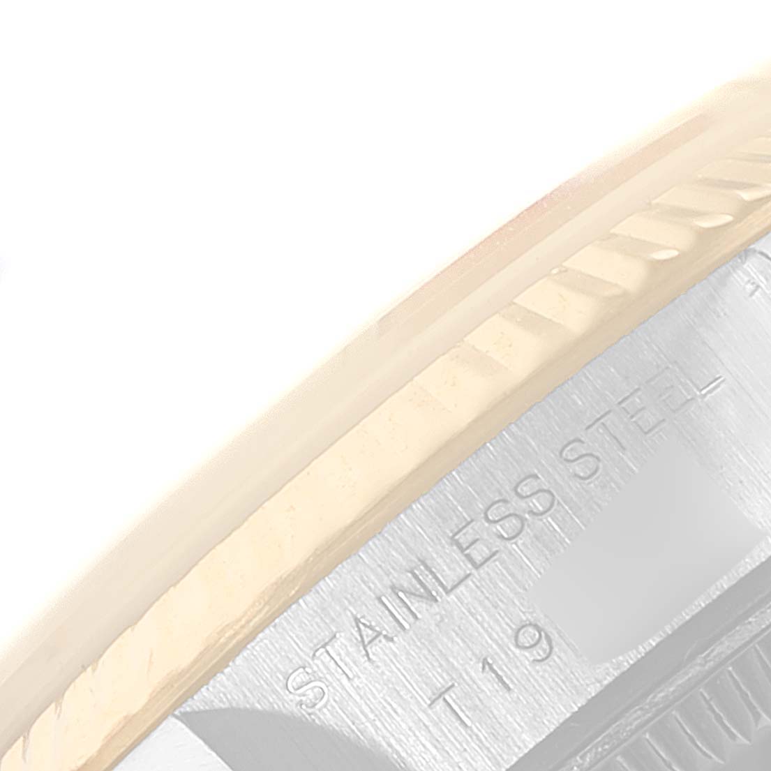 This close-up image shows part of the bezel and case of a Rolex Datejust 69173 Women's Steel and Gold (two tone) White Dial 69173 Women's Steel and Gold (two tone) White Dial watch.