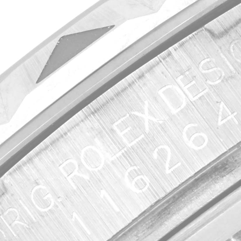 This close-up image shows the engraved serial number on the bezel of a Rolex Turn-o-Graph 116264 Men's Stainless Steel Black Dial 116264 Men's Stainless Steel Black Dial watch.
