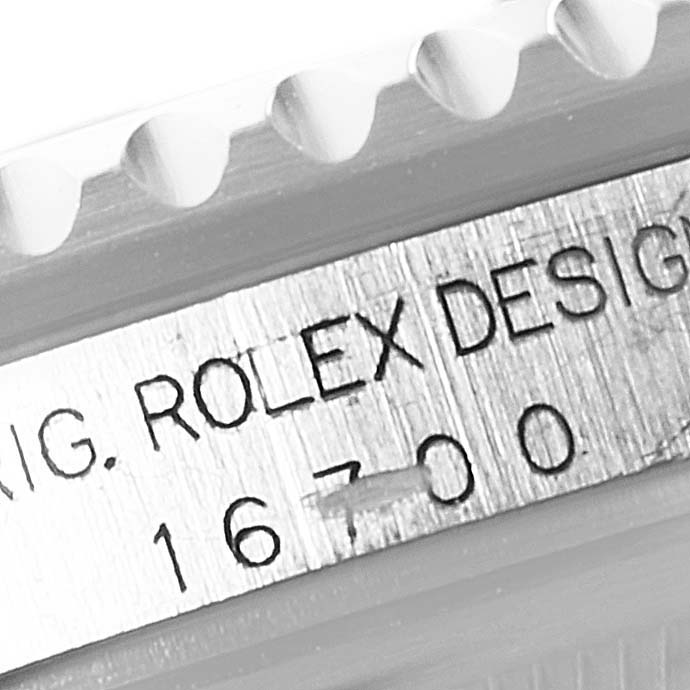 This close-up image of a Rolex GMT-Master 16700 Men
s Stainless Steel Black Dial 16700 Men
s Stainless Steel Black Dial shows the model number "16700" and the Rolex design engraving.