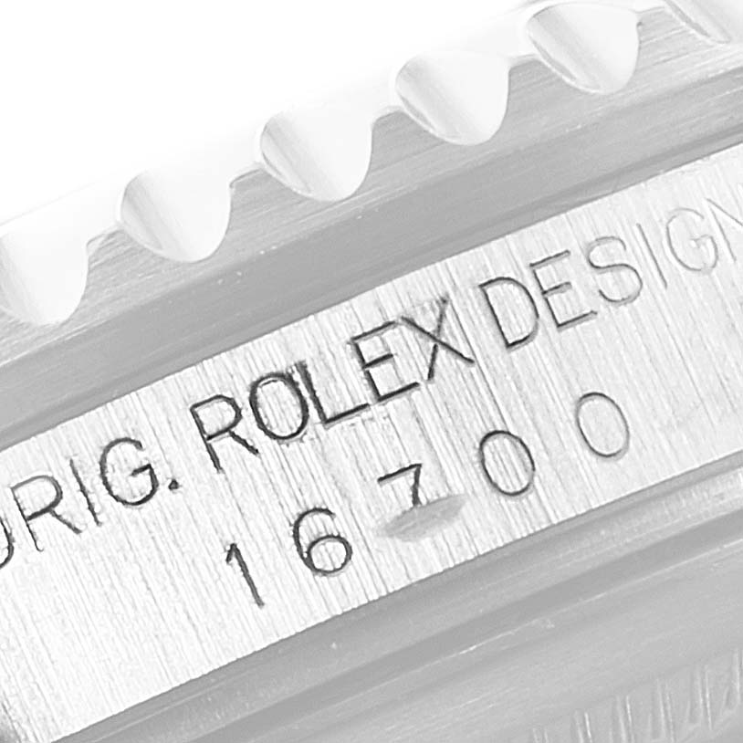 The image shows an engraved side view of the Rolex GMT-Master 16700 Men
s Stainless Steel Black Dial 16700 Men
s Stainless Steel Black Dial model indicating model number 16700 and the brand name.