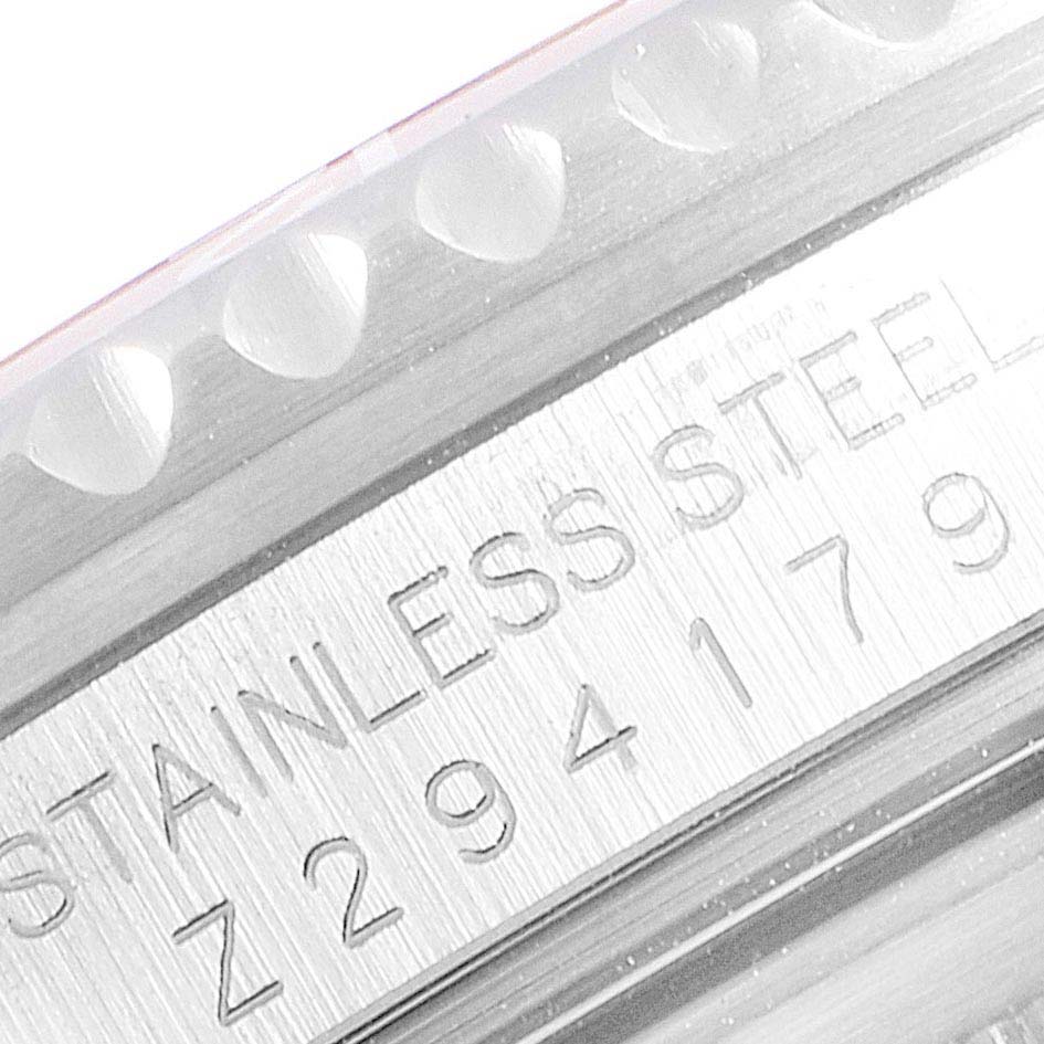 This image shows a close-up of the engraved serial number and "STAINLESS STEEL" marking on a Rolex GMT-Master 16710 Men's Stainless Steel Black Dial 16710 Men's Stainless Steel Black Dial watch bezel.