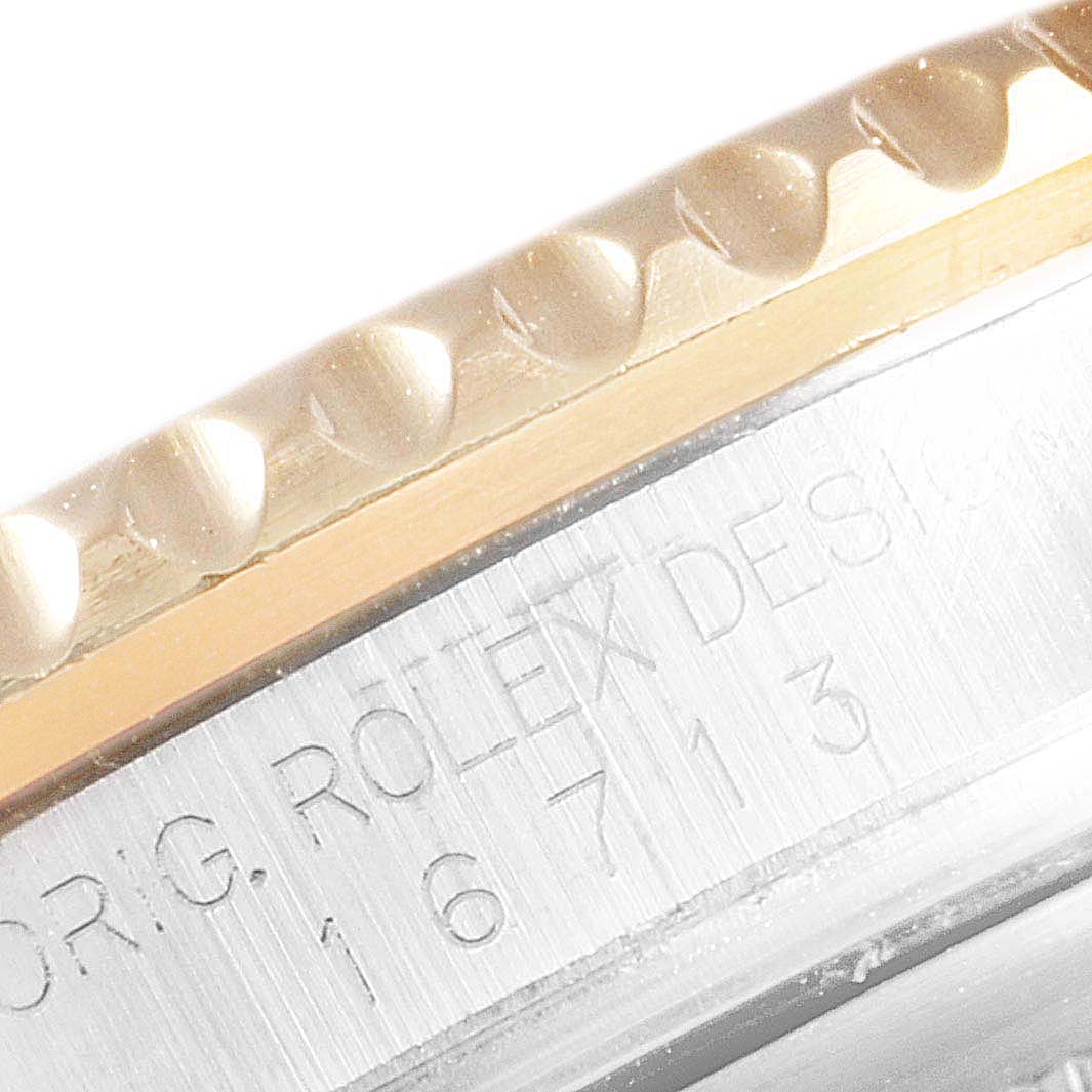 The image shows a close-up of the bezel and case of the Rolex GMT-Master 16713 Men's Steel and Gold (two tone) Brown Dial 16713 Men's Steel and Gold (two tone) Brown Dial, highlighting the model number engraving.
