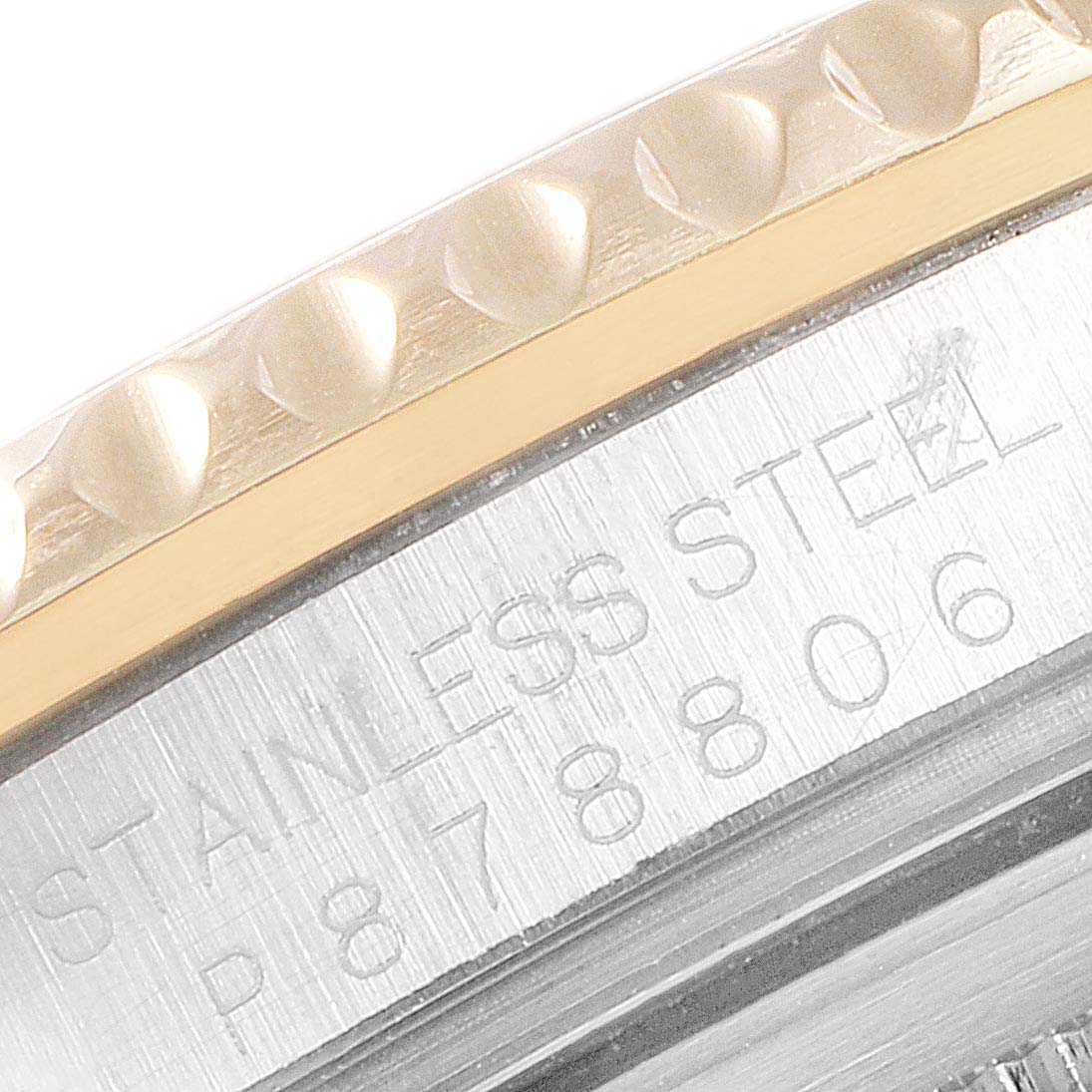 This close-up image shows the watch's bezel and part of the stainless steel case back of a Rolex GMT-Master 16713 Men's Steel and Gold (two tone) Brown Dial 16713 Men's Steel and Gold (two tone) Brown Dial.