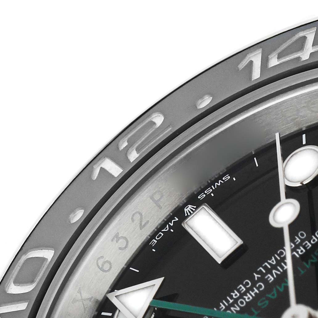 The image shows a close-up of the bezel and part of the dial of a Rolex GMT-Master 126710GRNR Men's Stainless Steel Black Dial, displaying the 12 and 14-hour markers.