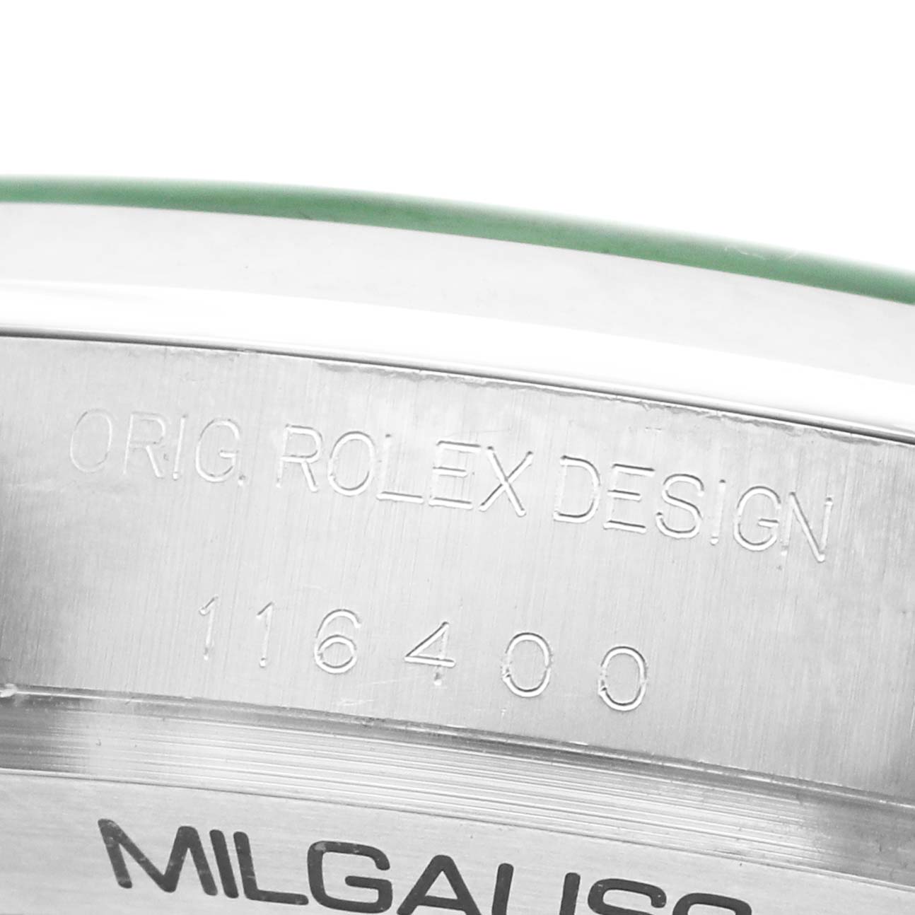 The image shows a close-up of the side of a Rolex Milgauss 116400GV Men's Stainless Steel Black Dial watch case with model engraving.