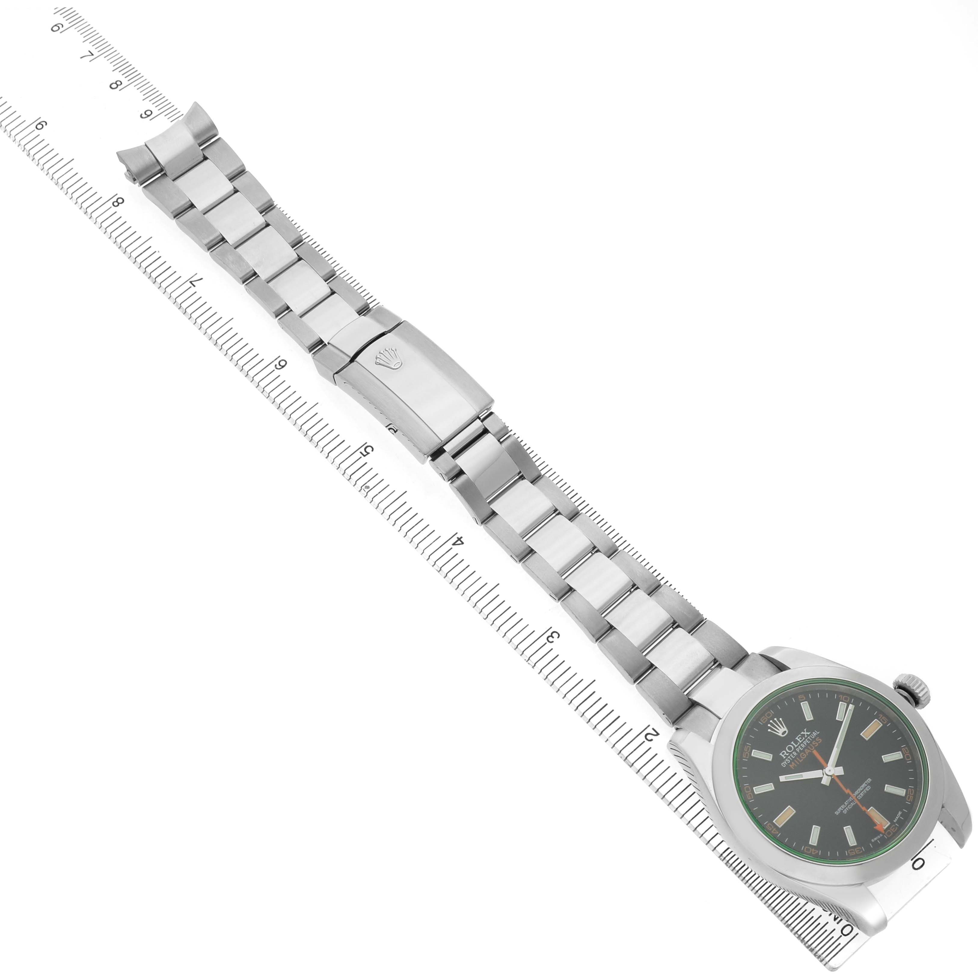 The image shows a Rolex Milgauss 116400GV Men's Stainless Steel Black Dial watch at an angle displaying the face, bracelet, and clasp, aligned alongside a ruler.
