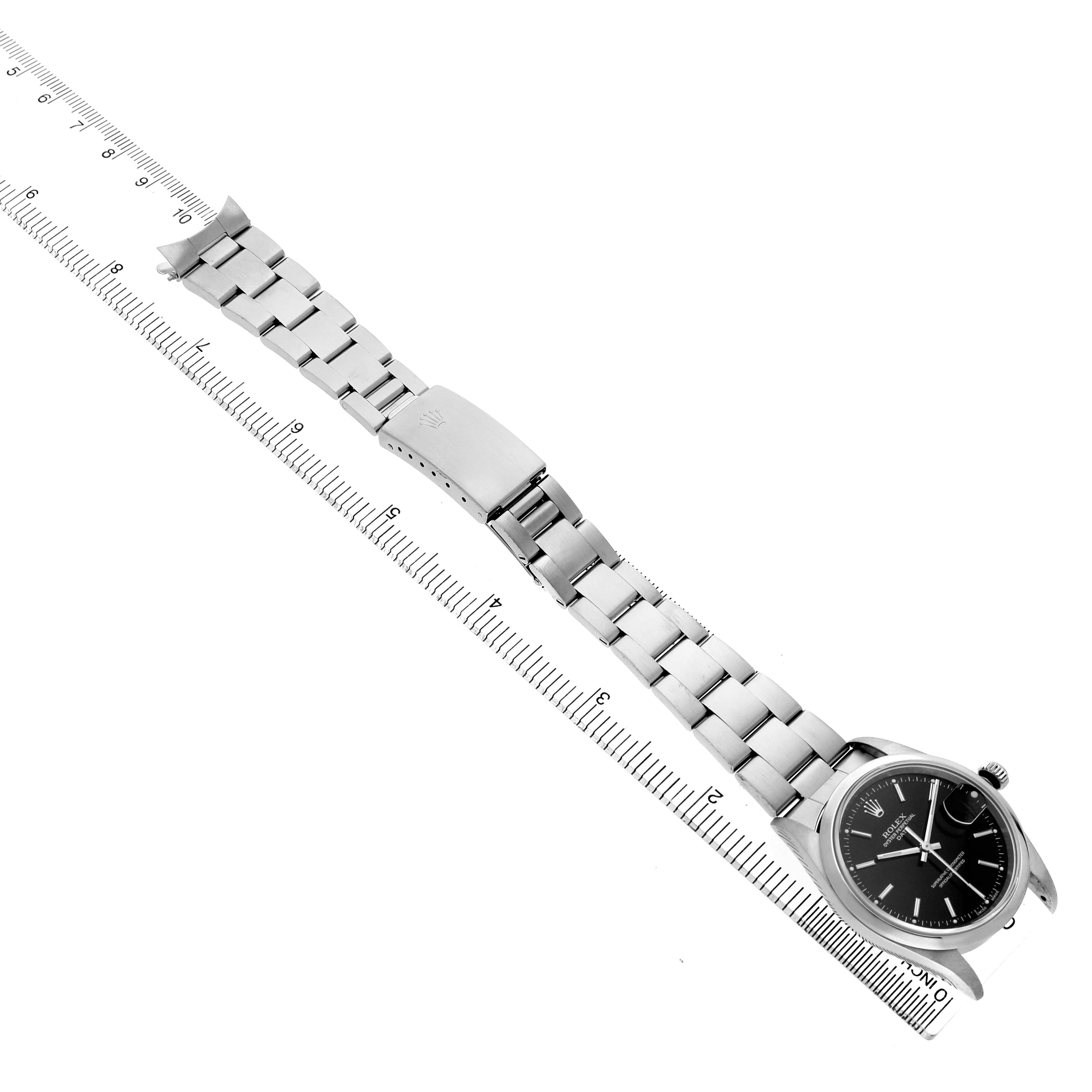 The image shows a Rolex Date 15200 Men's Stainless Steel Black Dial watch displayed from an angled top view, highlighting the bracelet and clasp alongside a ruler for scale.