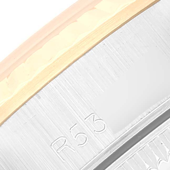 This image shows a close-up of the bezel and serial number on an Oyster Perpetual model by Rolex.