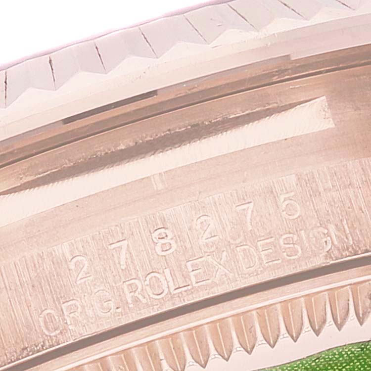 This close-up shows the engraved model number and part of the bezel of a Rolex President 278275 Women's Rose Gold Blue Dial 278275 Women's Rose Gold Blue Dial watch.