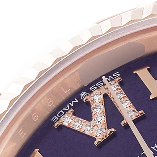 The image shows a close-up of the dial and bezel of a Rolex President 278275 Women's Rose Gold Blue Dial 278275 Women's Rose Gold Blue Dial watch, showcasing diamond-studded Roman numeral markers.