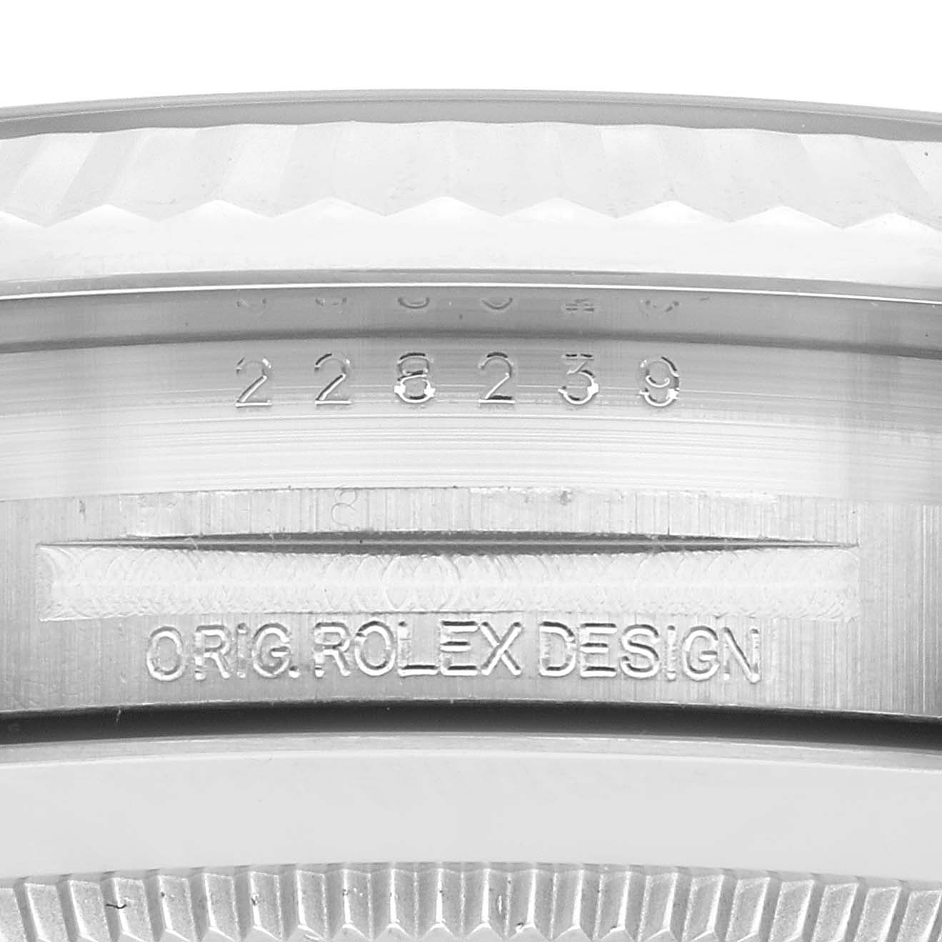 The image shows a close-up of the serial number and "ORIG ROLEX DESIGN" engraving on a Rolex President 228239 Men's White Gold Silver Dial 228239 Men's White Gold Silver Dial model's case.