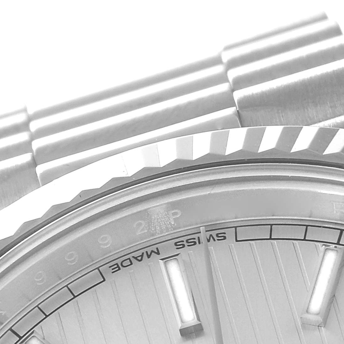 This image shows a close-up of the President model Rolex watch, focusing on the band, bezel, and part of the dial with "Swiss Made" text.